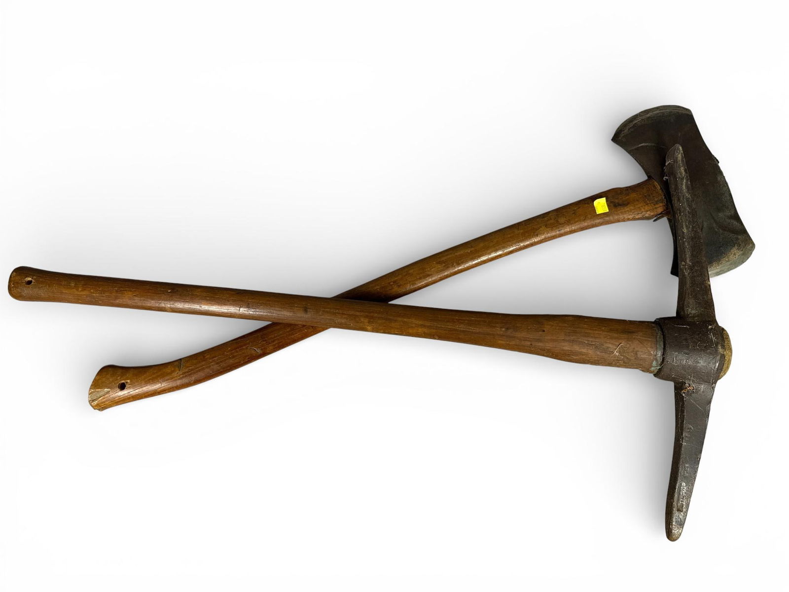 True Temper Kelly Works, Double-Bit Axe and Pickaxe, Mid-20th Century: This lot features two vintage industrial-grade striking tools. The primary item is a True Temper Kelly Works double-bit felling axe. The forged steel head is part of the Kelly Perfect line, characteri