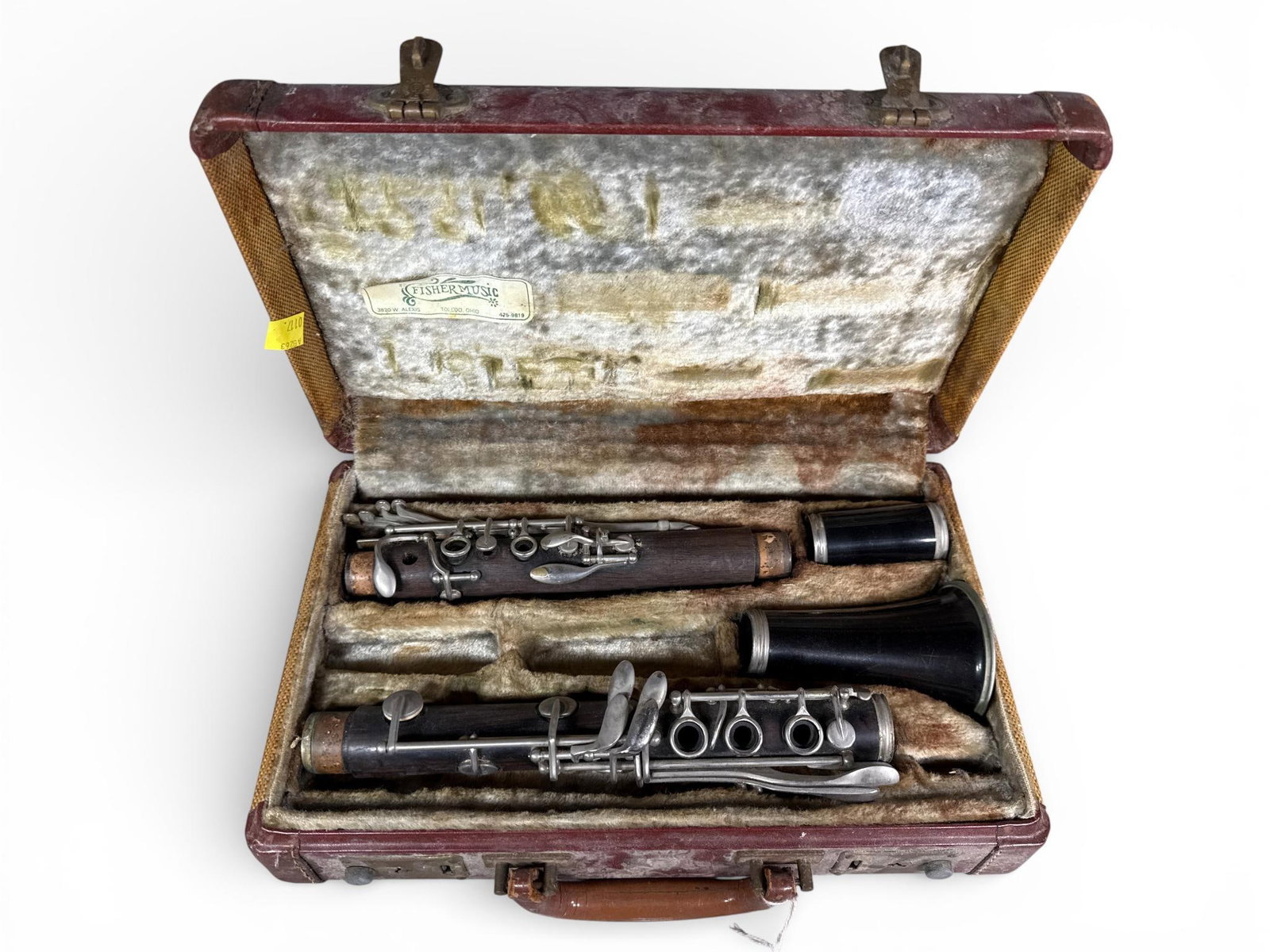 A Vintage Wood and Composite Clarinet in a Leblanc Case: A vintage clarinet featuring a dark wood body with silver-toned metal keys and rings, accompanied by a black composite bell and barrel. The instrument is housed in its original fitted hard-shell case,