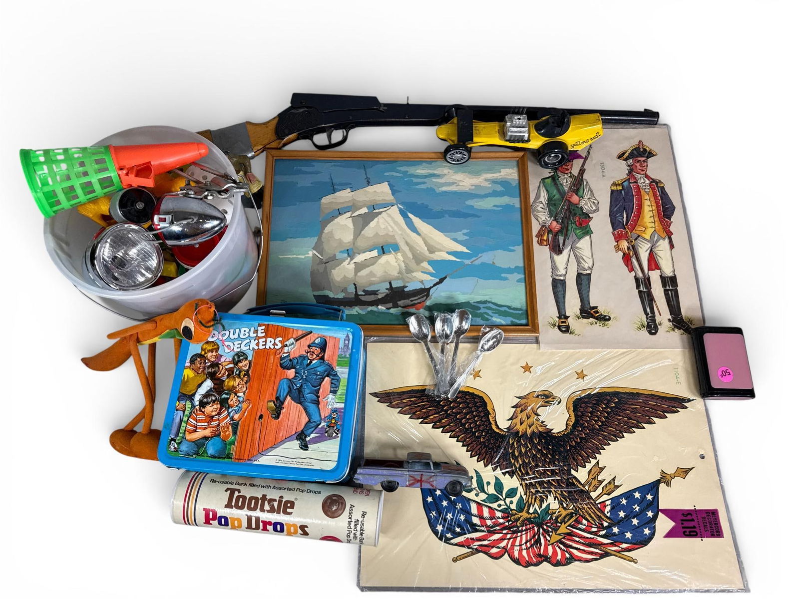 A Collection of Vintage Toys, Collectibles, and Miscellaneous Items: This collection includes a 1970 The Double Deckers lithographed metal lunchbox manufactured by Aladdin Industries. The lot also contains a Tootsie Pop Drops cardboard tube bank and Meyercord decorator