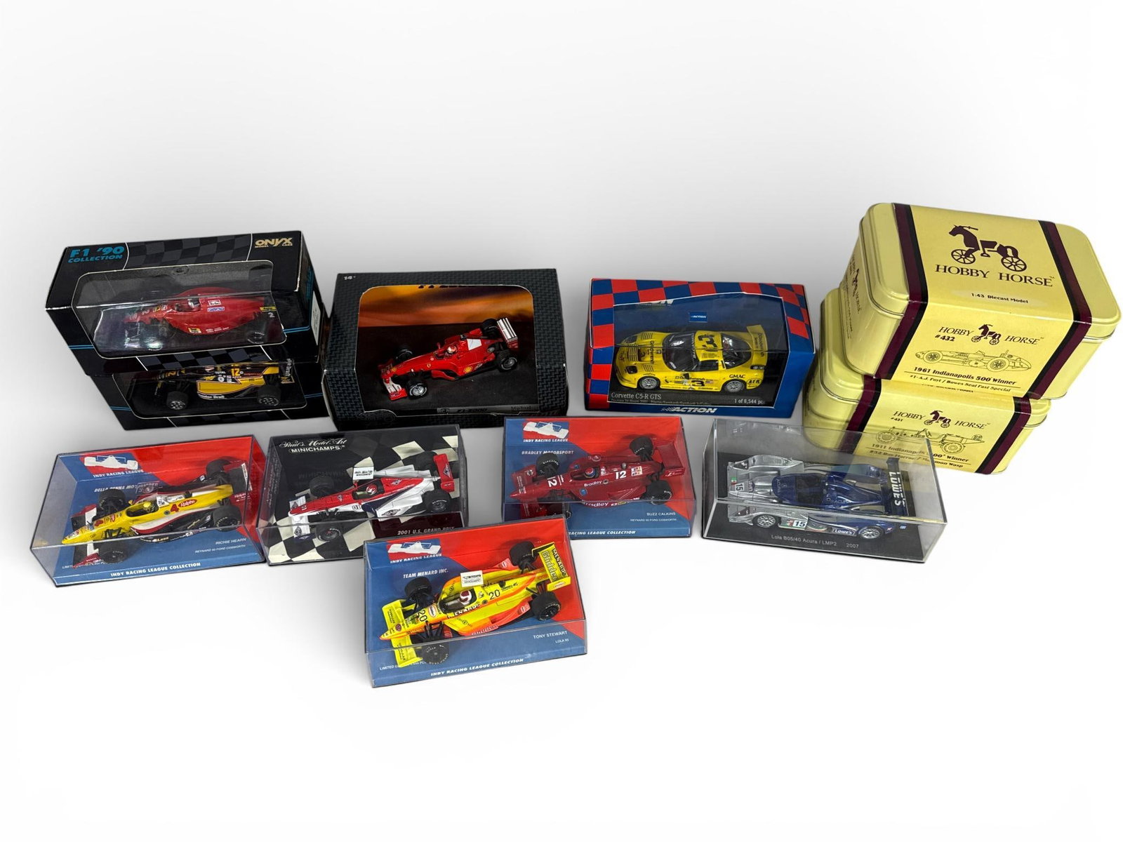 Collection of Eleven 1:43 Scale Diecast Racing Models, Minichamps, Hot Wheels, and Hobby Horse,: This professional collection features eleven 1:43 scale diecast model race cars representing Formula 1, IndyCar, and endurance racing disciplines. The assembly includes high-quality replicas from reno