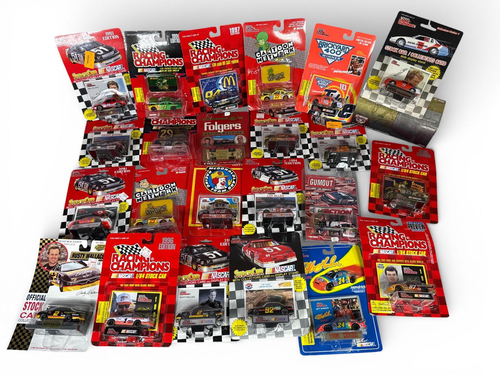 NASCAR Racing Champions Die-Cast Car and Collector Card Collection, 1993-1998: This collection features approximately 21 vintage NASCAR die-cast stock cars, primarily in 1/64 scale, dating from 1993 to 1998. Each car is accompanied by original paper ephemera in the form of a col