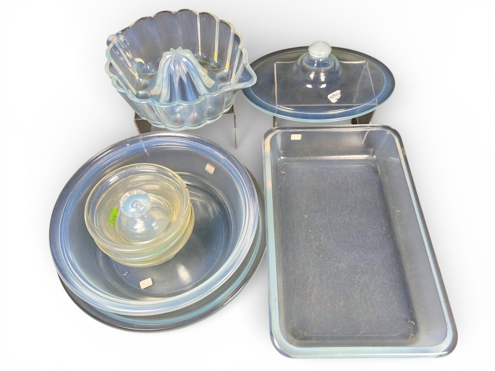 A group of H.C. Fry Oven Glass Opalescent Kitchenware Items: A group of pieces of American opalescent glass kitchenware manufactured by the H.C. Fry Glass Company under the "Oven Glass" line. The glassware exhibits a characteristic milky blue-white opalescence,