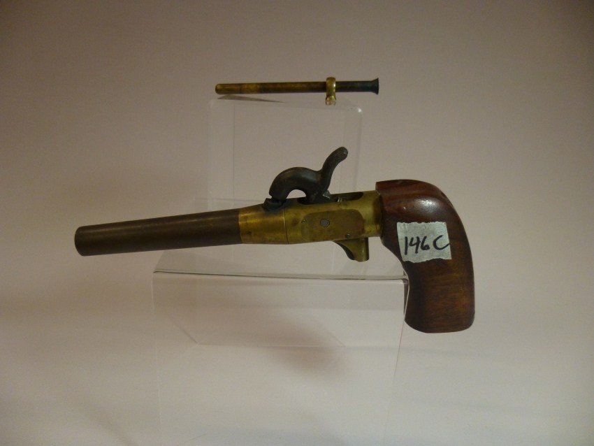 Brass and wood cap and ball pistol.: 8.25” long. Shipping 12.