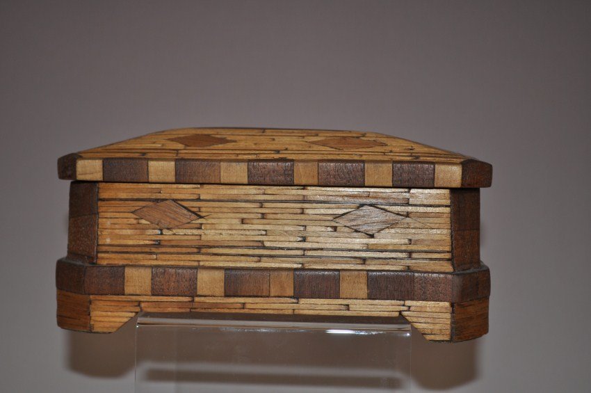 Tramp art or folk art coffin-shaped box.: 8.5” long x 3.75” deep x 4” tall.