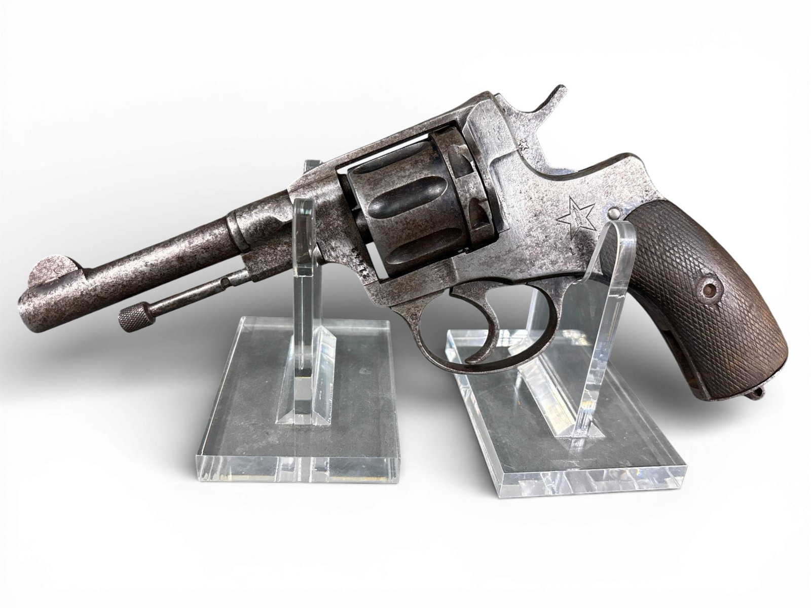** Tula Russian Nagant Model 1895 Revolver: A Russian Nagant Model 1895 revolver manufactured at the Tula Arsenal. This firearm is chambered in 7.62 x 38R and features a 4.5-inch barrel with fixed sights. The left side of the frame is stamped