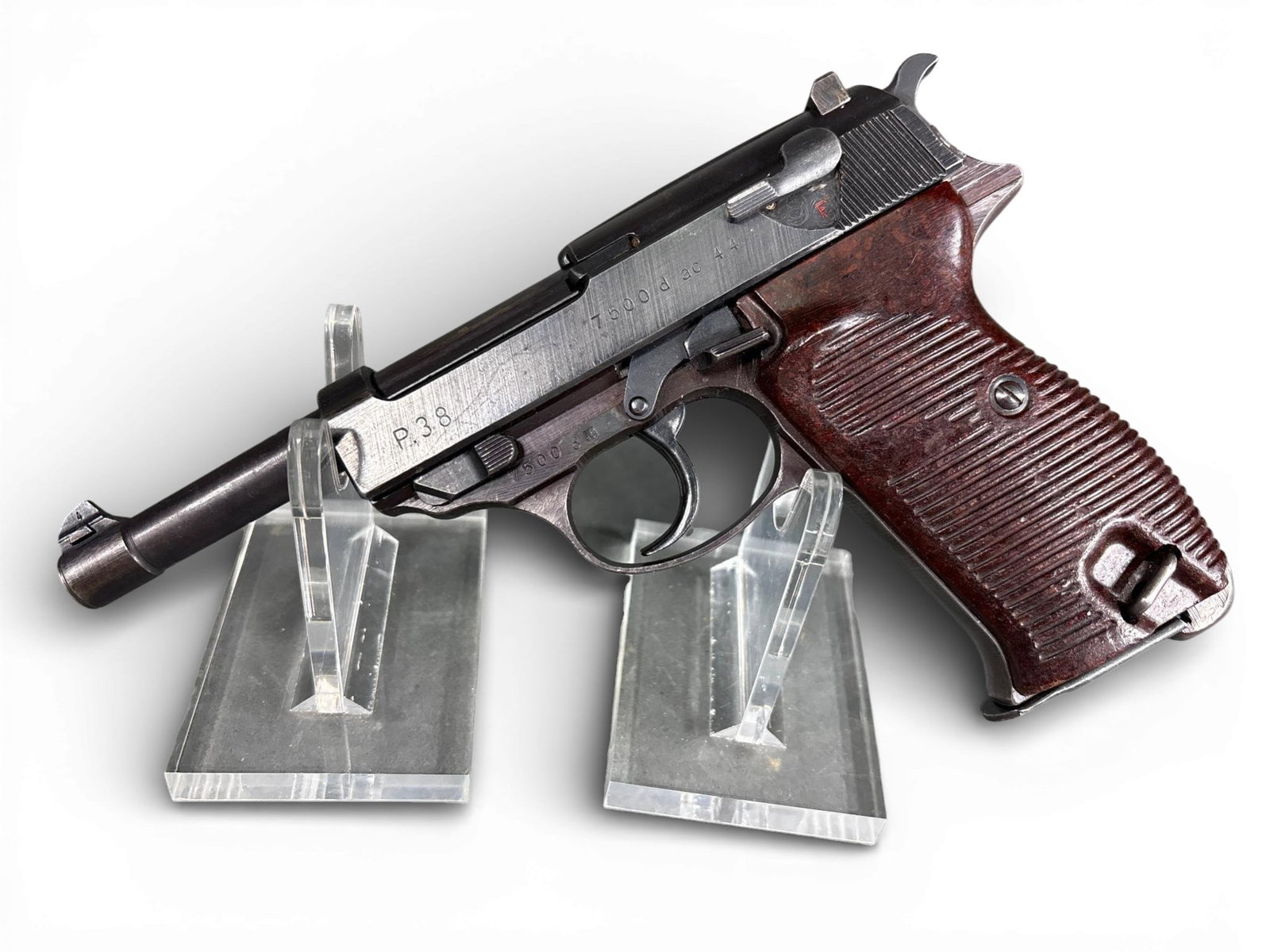 ** Walther P.38 Semi-Automatic Pistol, ac 44 Code: A World War II era Walther P.38 semi-automatic pistol manufactured by Carl Walther Waffenfabrik in 1944. The firearm is chambered in 9mm Parabellum and features a blued steel finish with