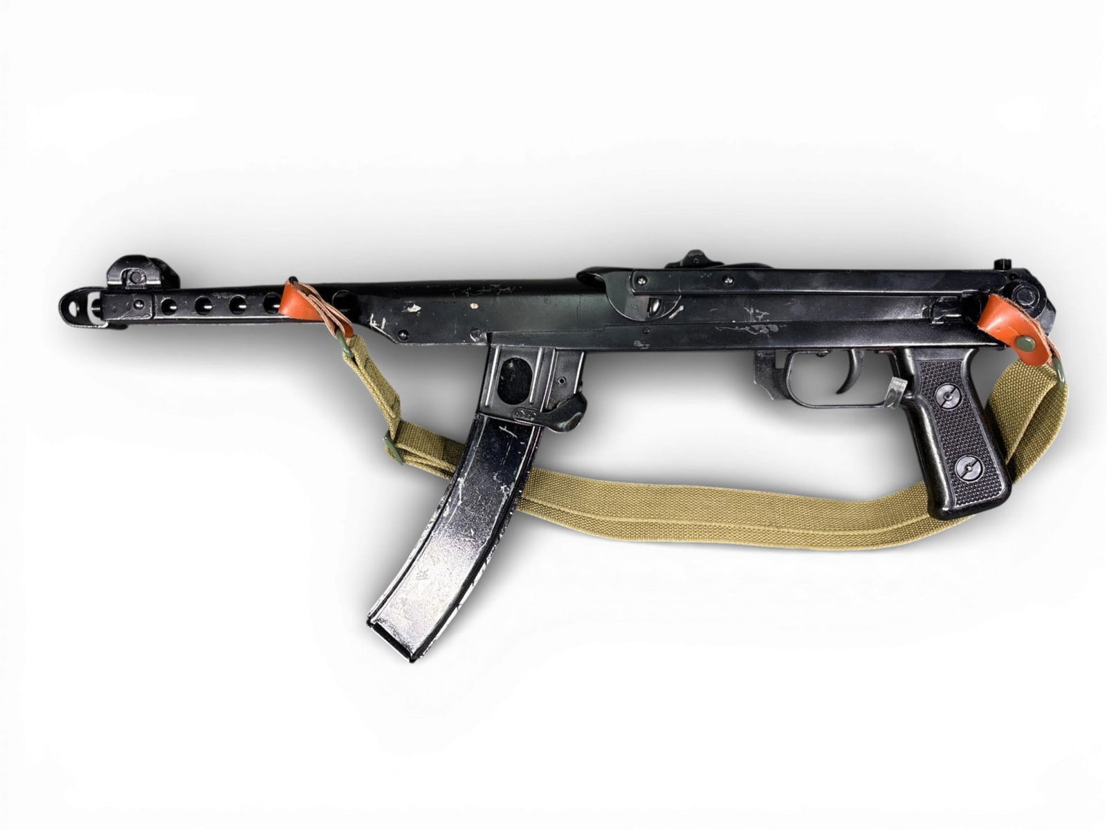 Russian PPS-43C Non-Firing Display Rifle: This Russian-manufactured PPS-43C pattern non-firing rifle is constructed of stamped steel with a black finish. The design features a perforated barrel shroud and a top-folding metal stock. The item