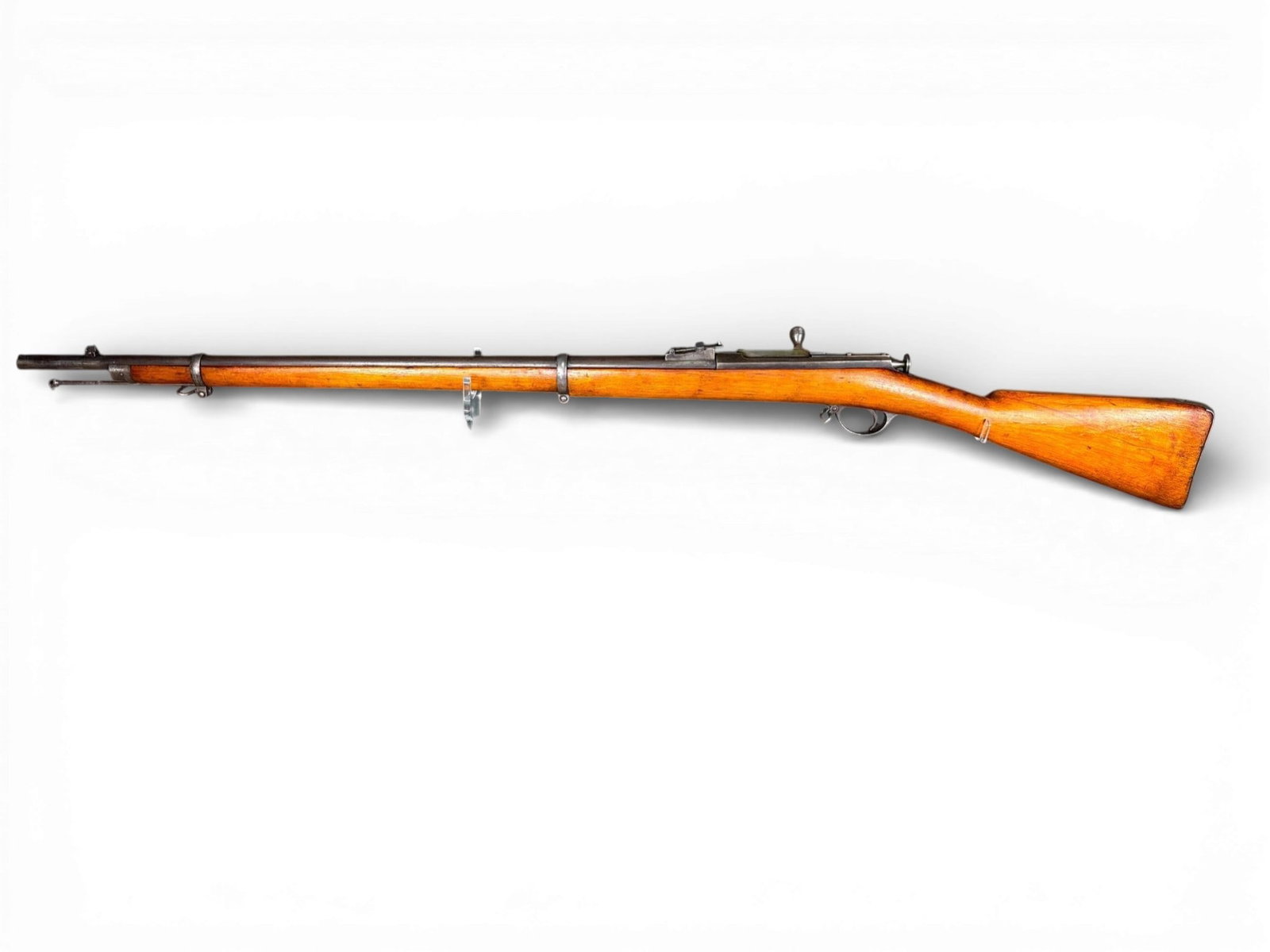 Russian Berdan II Bolt-Action Military Rifle: A Russian Berdan II single-shot bolt-action rifle chambered in .42 Russian Berdan. The firearm features a 33-inch round steel barrel and a full-length wooden stock. The top of the barrel displays