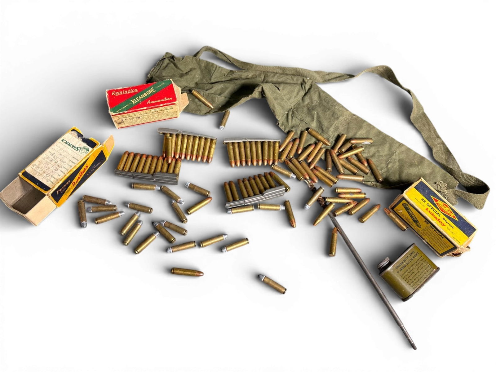 An Assortment of Vintage Ammunition and Maintenance Accessories Including 30 Cal for M1 and WWII: This collection comprises an assortment of vintage ammunition and firearm maintenance equipment. The lot includes multiple .30 caliber carbine cartridges, specifically for the M1 carbine, with several