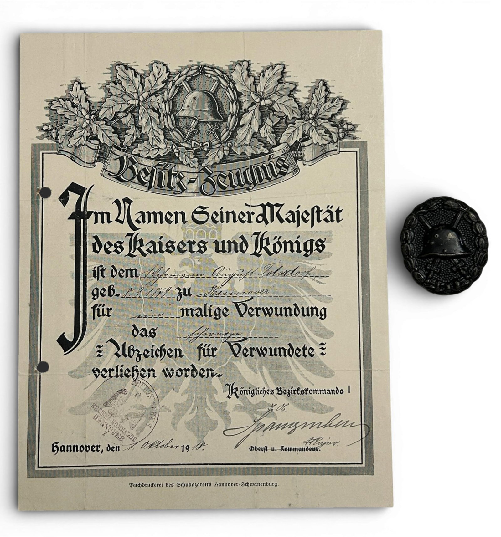 WWI Imperial German Wound Badge & Certificate: World War One German wound badge in black (3rd class) and certificate issued October 1, 1918. The document measures 6.625" x 8.625" and bears a Hannover district stamping.It was printed at the "Printi