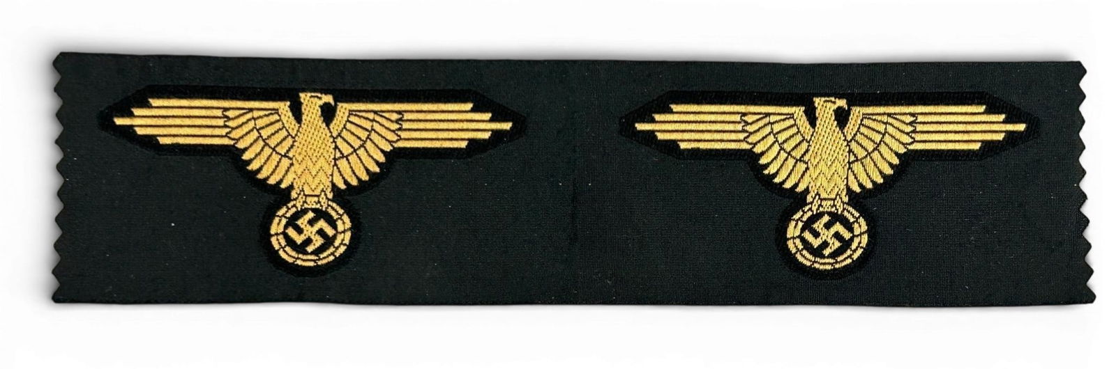 WWII Nazi German Waffen SS Tropical Eagles (2) Uncut From Roll: World War II German Waffen SS Tropical EM Sleeve Eagles. Includes 2 eagles uncut from a roll. The 2-eagle strip measures 7.875” x 1.94”. Uncut on a roll. Machine embroidered cloth woven be