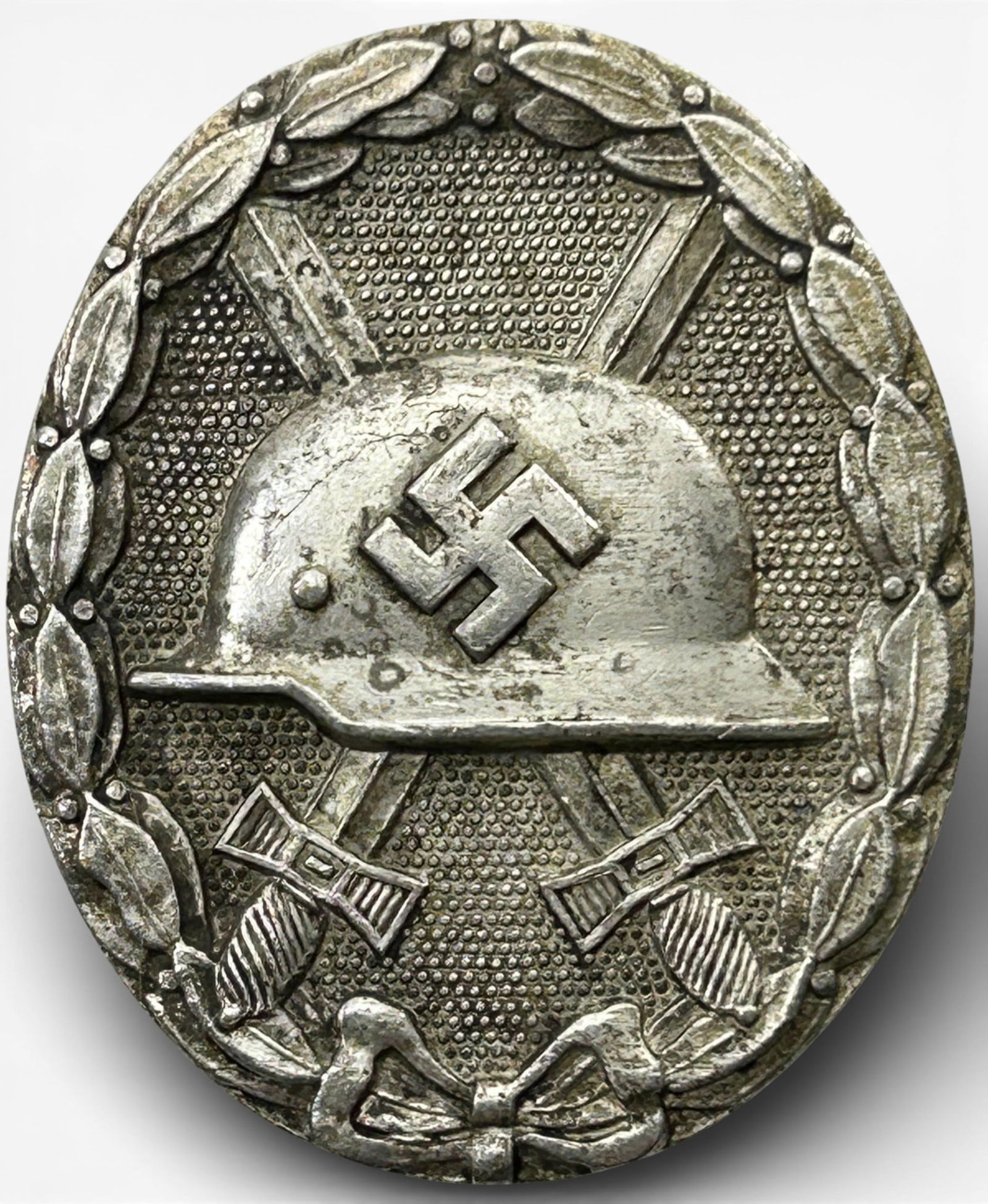 WWII Nazi German Silver Wound Badge: German World War II silver wound badge. Measures 1.44” x 1.75" The reverse side is maker marked ‘30’. Has a wide vertical pin back with a ‘c’ catch. One piece solid die struck nickel con
