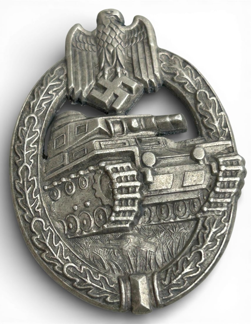 WWII Nazi German Army HEER Silver Tank Assault Badge: German WWII Army HEER Silver Tank Assault Badge. Measures 1.625”x 2.375". The front shows a tank in the center with an army eagle clutching a swastika in his talons at the top. Both are surround
