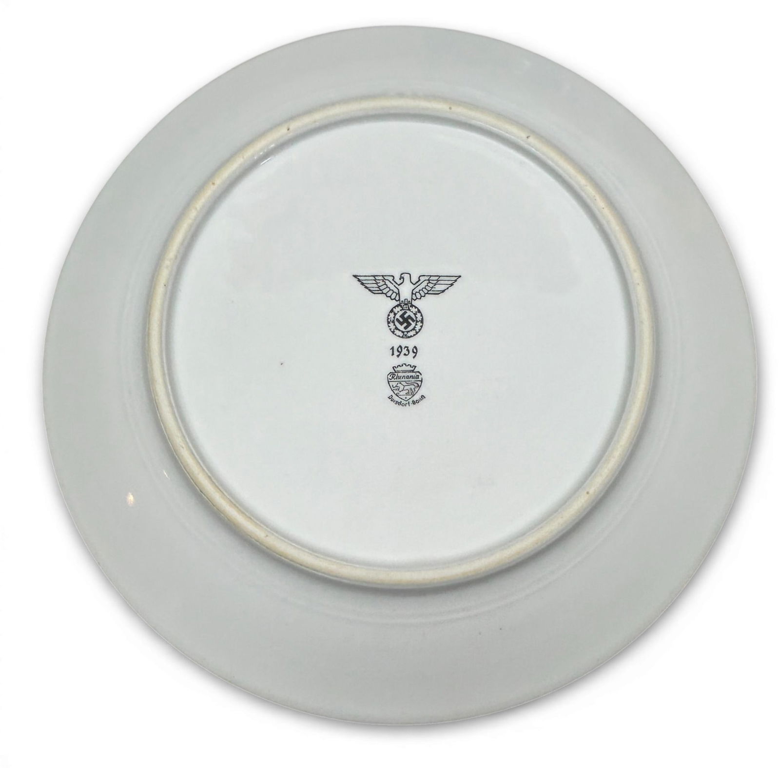 WWII Nazi German Wehrmacht - Heer 1939 Porcelain Dinner Plate by Rhenania Co Duisdorf-Bonn: World War II Nazi German Wehrmacht - Heer porcelain dinner plate. The obverse is plain and the reverse is stamped with an eagle clutching a wreathed swastika, a manufacture date of 1939 and maker's ma