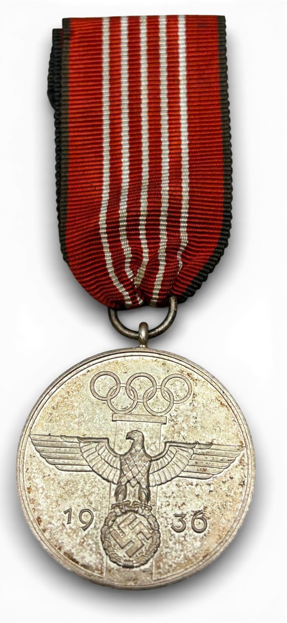 WWII Nazi German 1936 Olympics Service Medal: German WWII 1936 Berlin Summer Olympics Service medal. measures 1.5" in diameter. The front shows an eagle clutching a swastika in his talons in the center. There are five Olympic rings at the top and