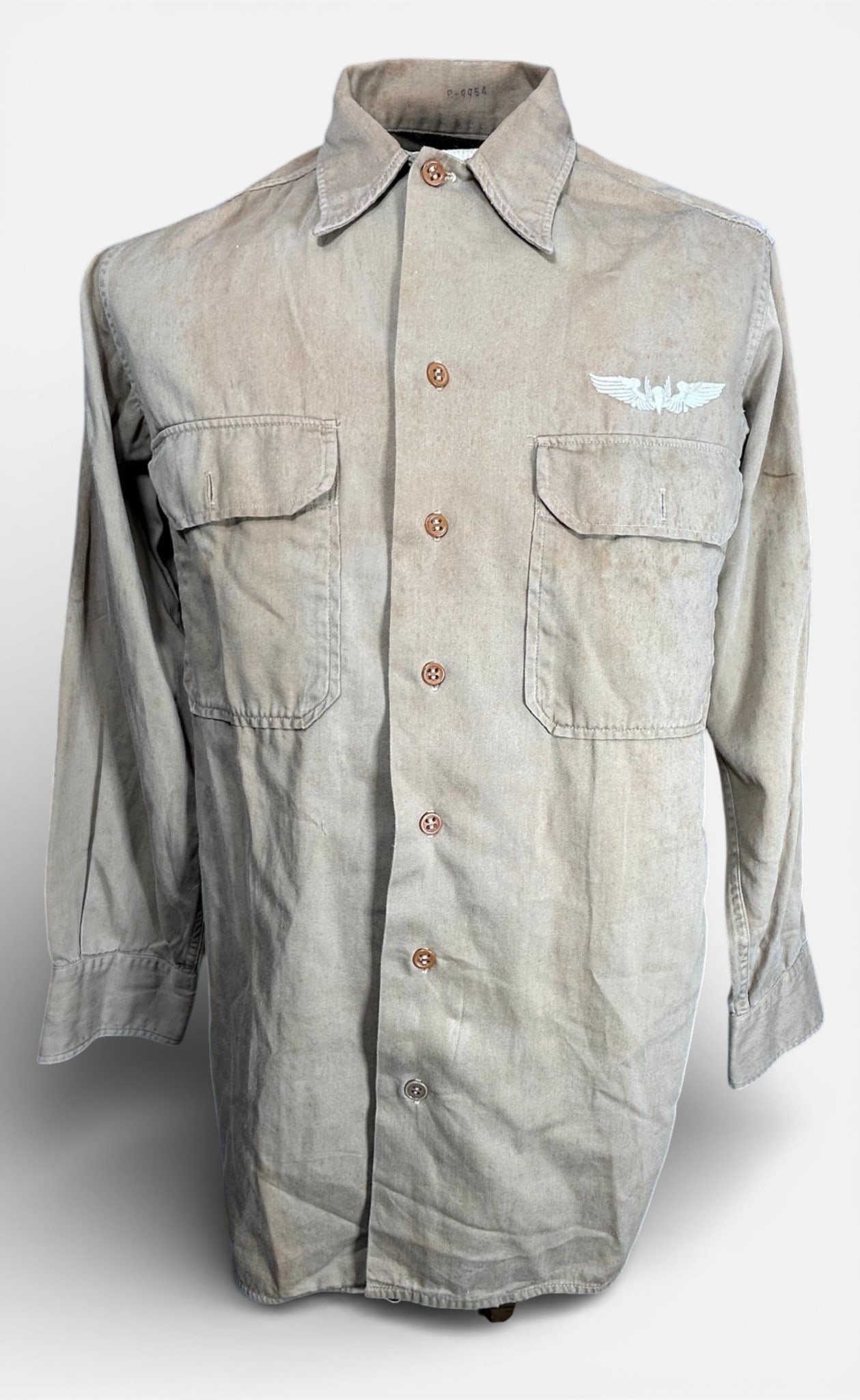 WWII United States AAF Shirt With CBI Theater Gunners Wings Directly Embroidered to the Shirt: World War Two U.S. Army AAF tan shirt with CBI gunners wings embroidered directly onto the shirt. The embroidery appears to be Indian in style. The airman's laundry number, P - 9954 is written on the