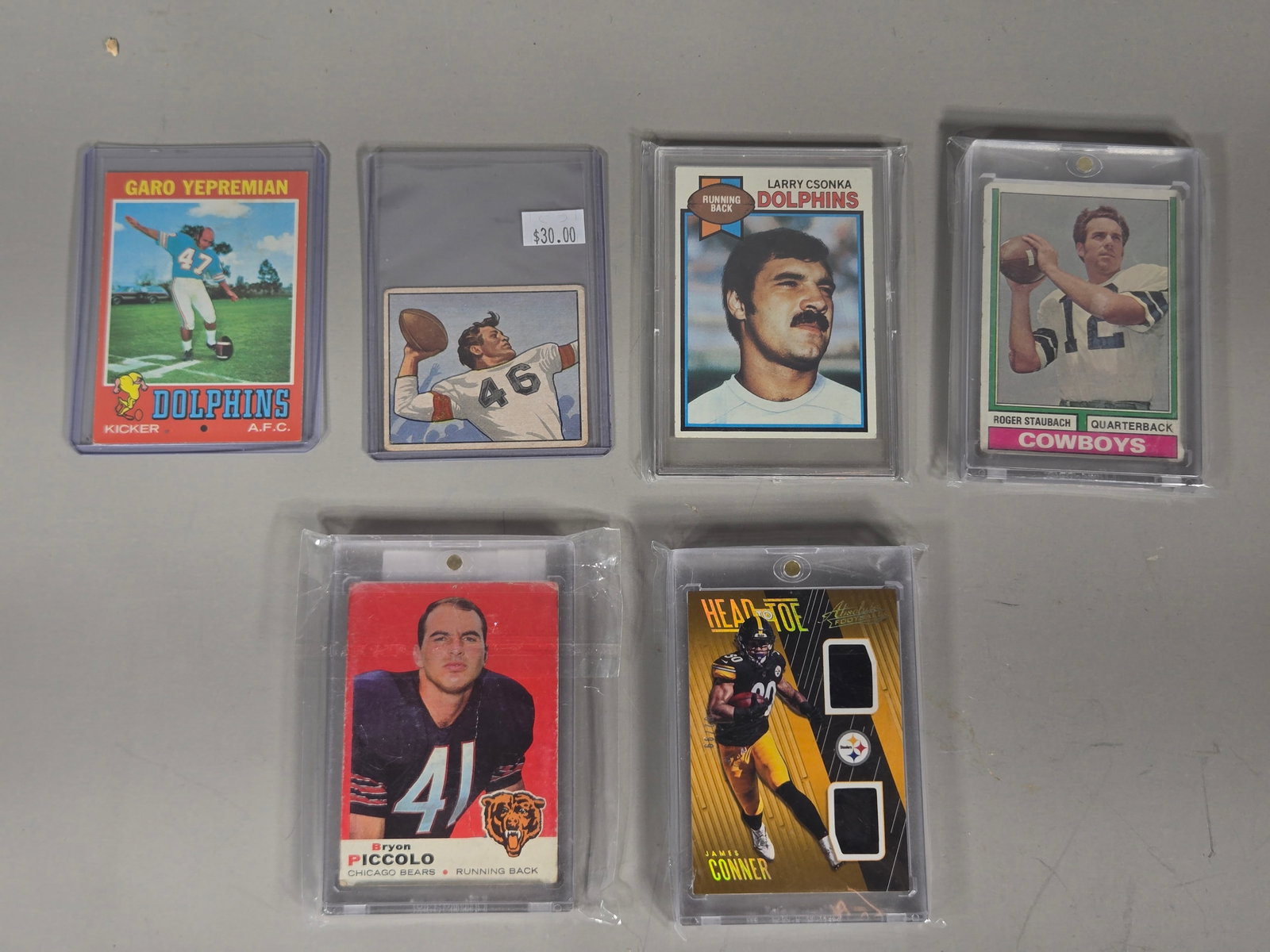 A Collection of Vintage and Modern American Football Trading Cards Including 1979 Topps Larry Csonka: A collection of American football trading cards from various manufacturers including Topps, Bowman, and Panini. The group features a 1979 Topps Larry Csonka #22 card. Other vintage cards include a 195