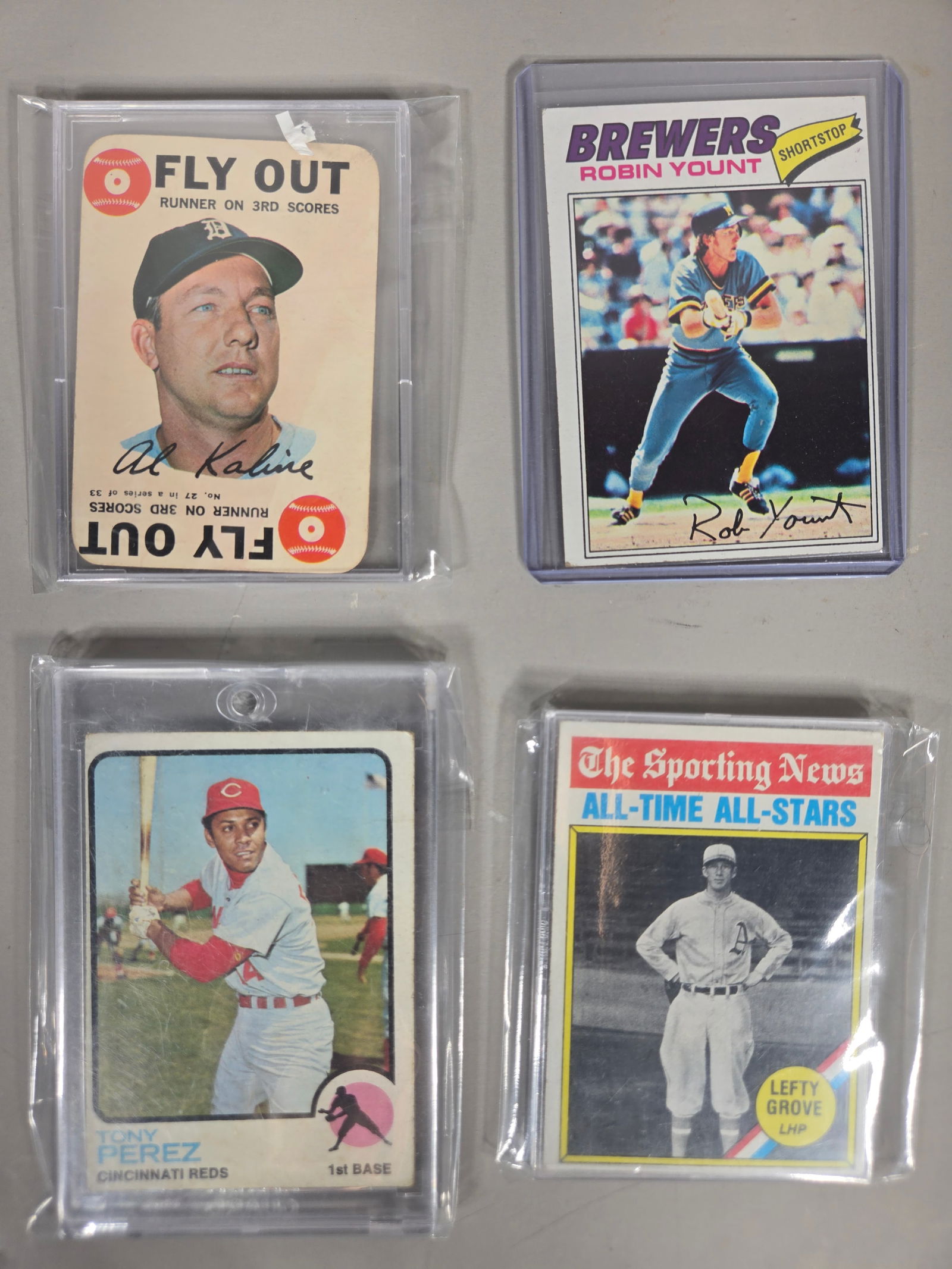 A Collection of Vintage Topps Baseball Trading Cards Featuring 1971 Pittsburgh Pirates Team Records: This collection of vintage Topps baseball trading cards features various issues from the 1960s and 1970s. The group includes a 1971 Pittsburgh Pirates team records card, a 1977 Robin Yount Milwaukee B
