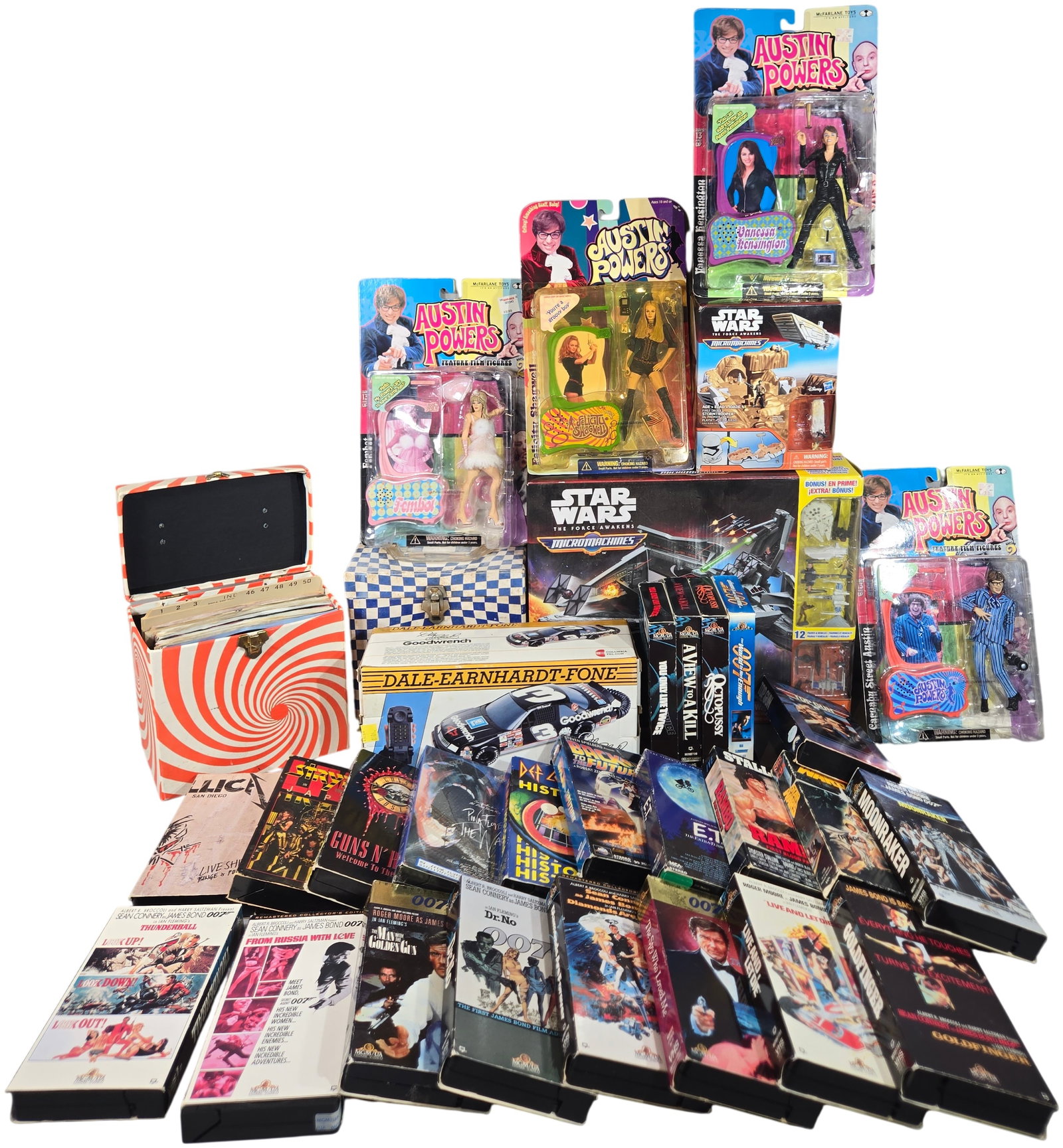 McFarlane Austin Powers Figures, James Bond VHS Collection, and Vintage 45 RPM Records, c. 1955-2015: This comprehensive collection of late 20th-century pop culture memorabilia features a diverse array of toys, media, and novelty electronics. The lot includes four carded action figures from McFarlane