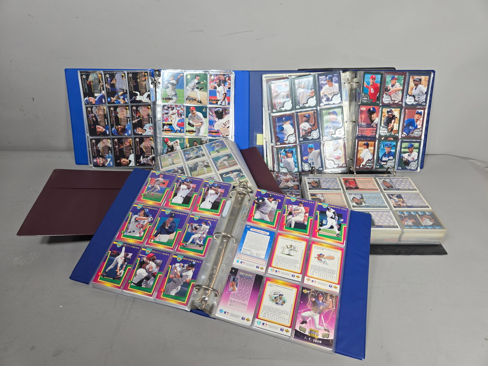 A Collection of 1990s Major League Baseball Trading Cards: An assortment of Major League Baseball trading cards primarily dating from the early to late 1990s. The collection includes cards from various manufacturers such as Upper Deck Collector's Choice, Topp