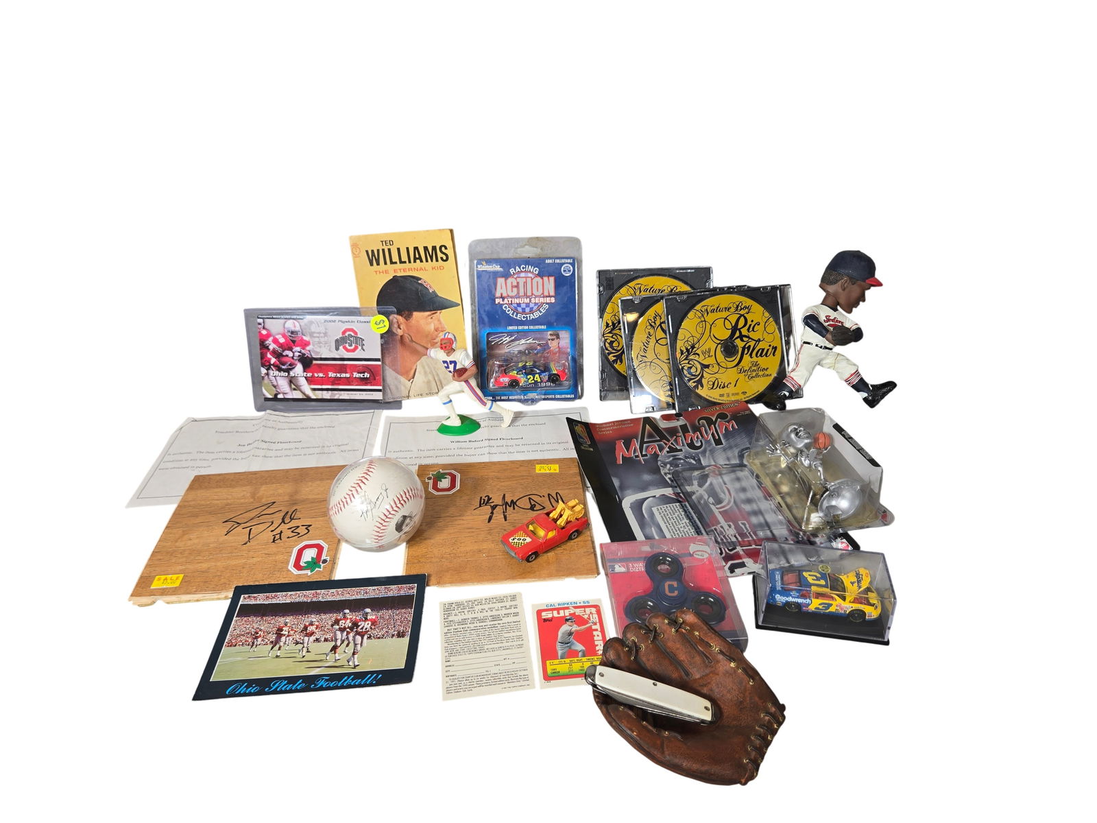 A Collection of Sports Memorabilia and Die-Cast Collectibles Including Jeff Gordon and Ken Griffey: This collection features an assortment of sports memorabilia and die-cast vehicles spanning various professional leagues and eras. A primary highlight is a 1996 Action Platinum Series Winston Cup Coll