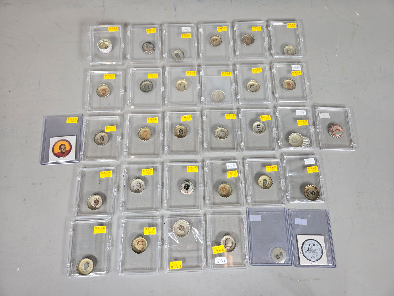 A Group of Mid-20th Century NFL Promotional Bottle Caps and Sports Tokens: A group of professional football memorabilia dating from approximately 1965 to 1971, individually housed in clear plastic coin slab display cases. The collection primarily consists of metal bottle cap