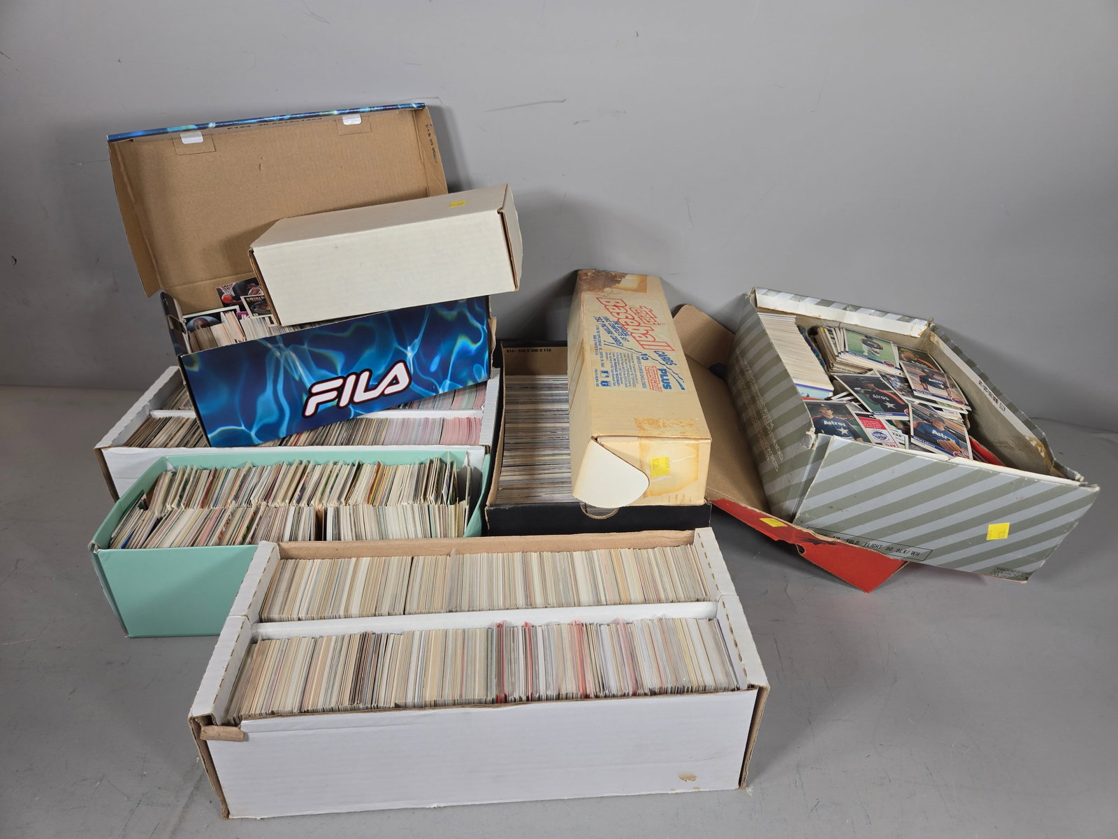 An Assortment of Vintage Sports Trading Cards and Collectibles: A collection of professional sports trading cards primarily dating from the late 1980s and early 1990s. The lot includes cards from various manufacturers such as Topps, Fleer, NBA Hoops, Stadium Club,