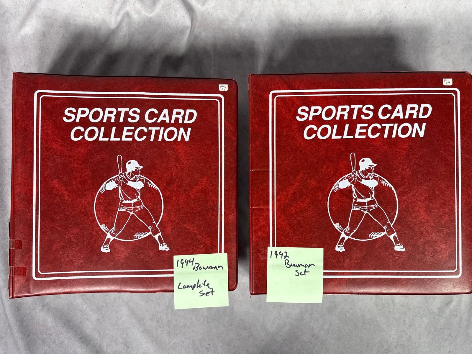 A Collection of 1992 and 1994 Bowman Baseball Trading Card Sets: This collection consists of two baseball trading card sets housed in red three-ring binders. The binders are finished in a red textured material featuring the printed title SPORTS CARD COLLECTION and
