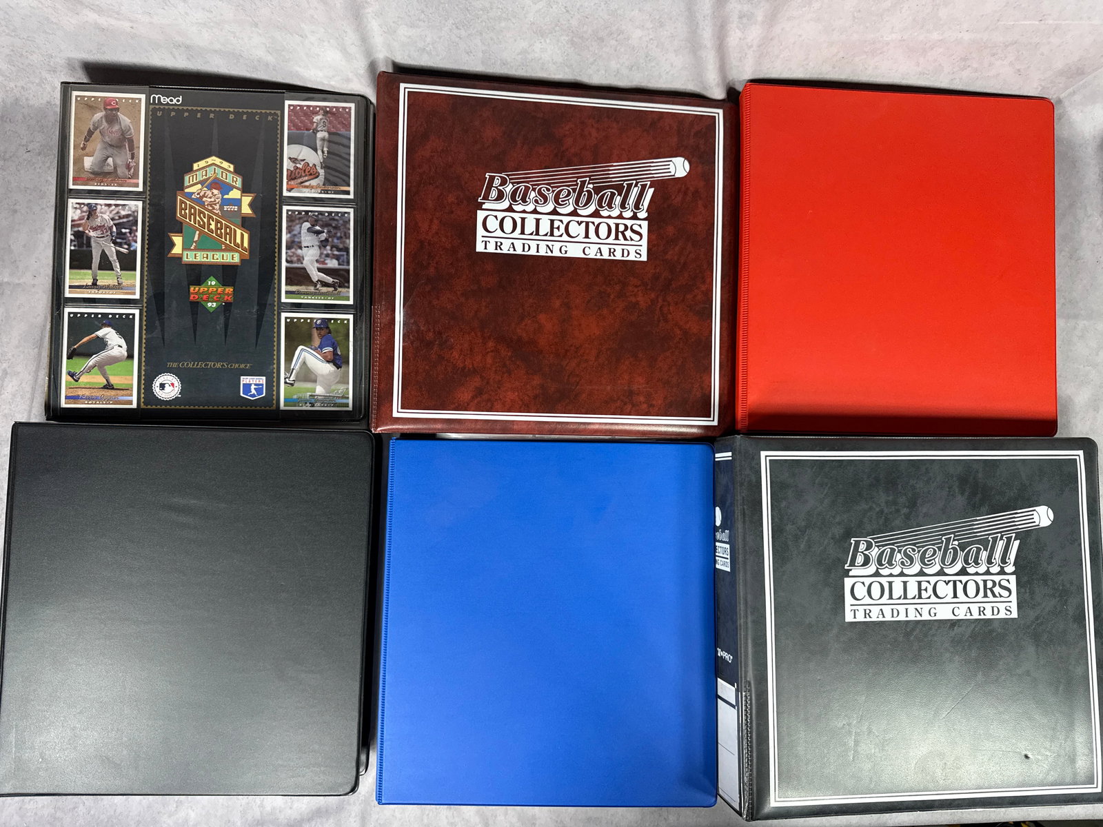 A Collection of Baseball Trading Card Binders and Cards: A collection of several baseball trading card binders containing an assortment of cards primarily from the early 1990s. The lot includes a black Mead binder with 1993 Upper Deck Major League Baseball