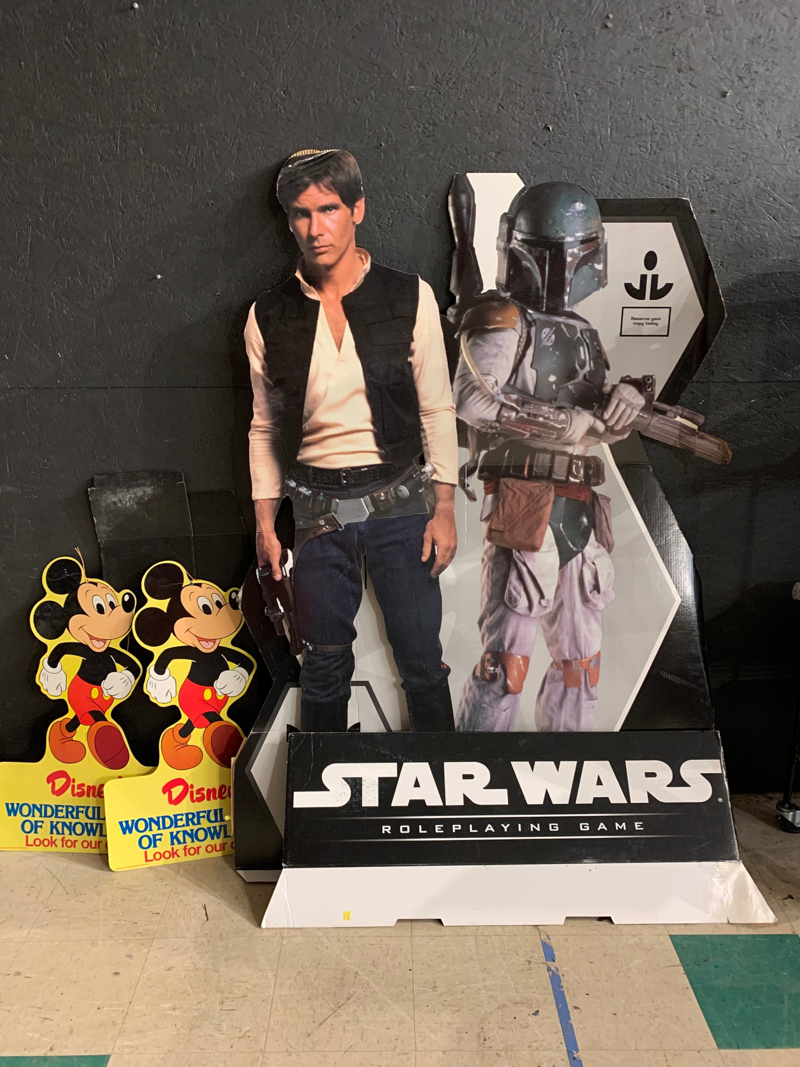A Collection of Star Wars and Disney Promotional Cardboard Standees and Cutouts: This collection of printed corrugated cardboard promotional materials features a multi-piece standee for the Star Wars Roleplaying Game and an assortment of Mickey Mouse cutouts. The Star Wars display