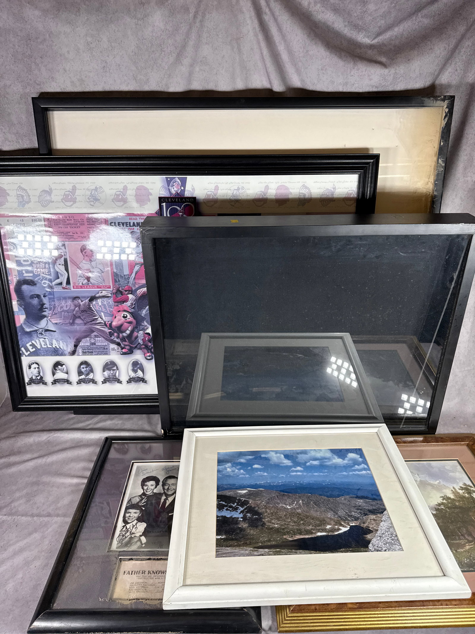 A Collection of Framed Wall Art and Memorabilia: This collection consists of an assortment of framed items including decorative prints and television and sports memorabilia. Included is a black and white cast photograph from the television program