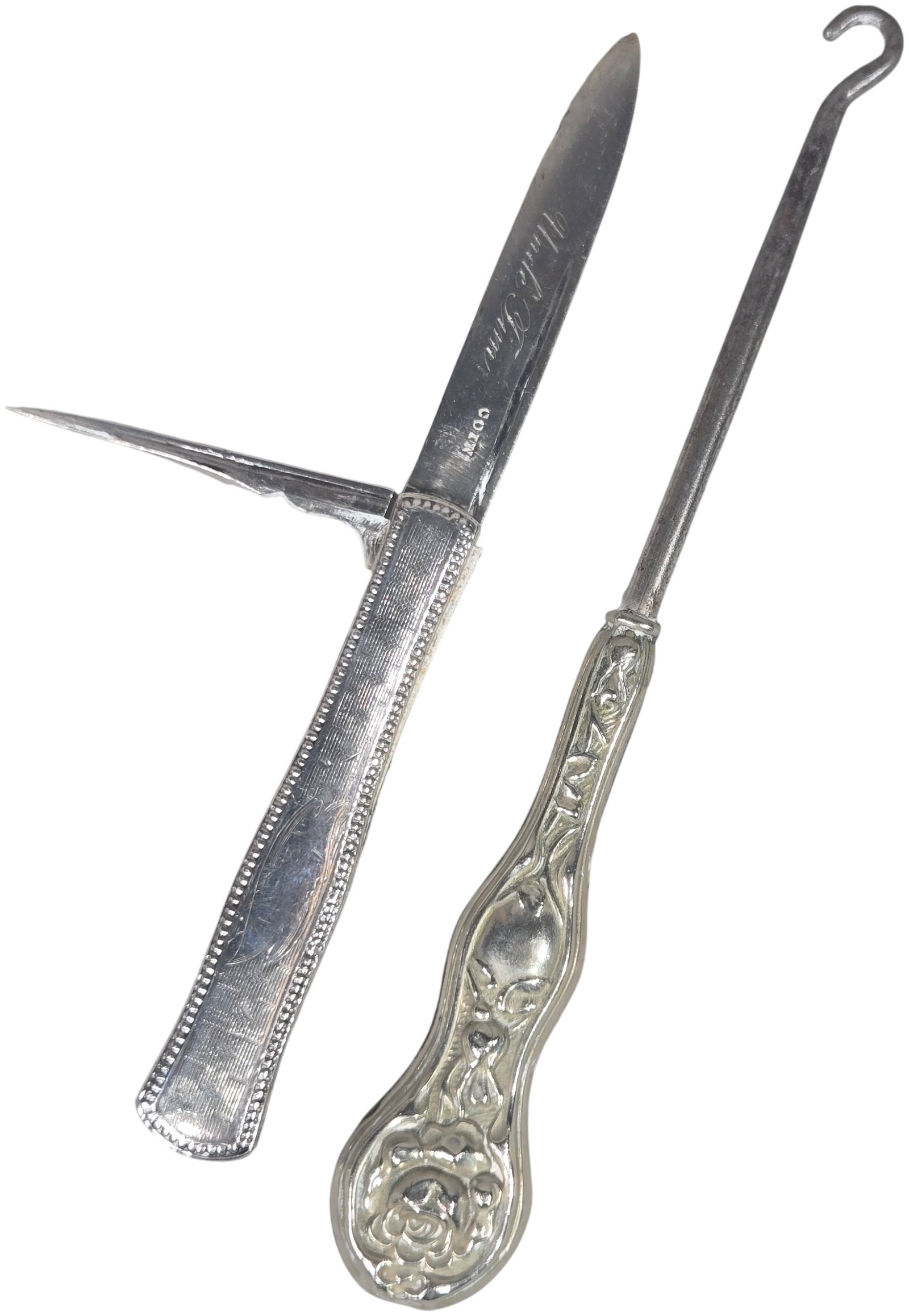 Victorian Engine-Turned Coin Silver Folding Tool and Art Nouveau Floral Repousse Sterling Silver: A pair of Victorian-era personal accessories. The first is a coin silver folding pocket tool featuring an engine-turned geometric pattern handle with beaded borders and a vacant oval cartouche. The to