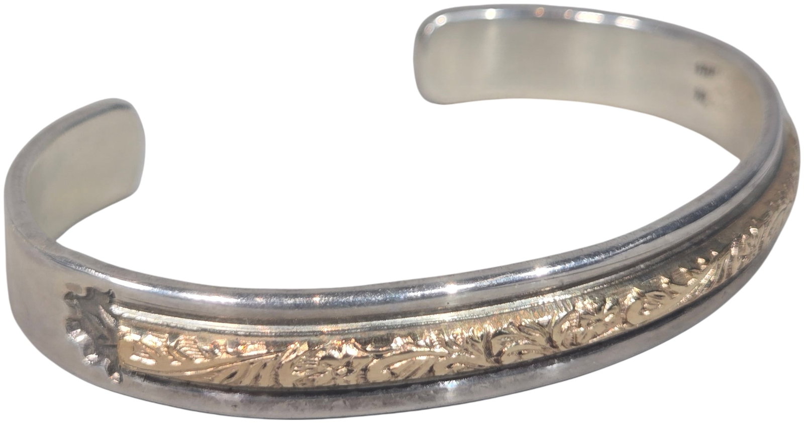 Sterling Silver and 12 Karat Gold-Filled Foliate Scroll Cuff Bracelet: A handmade two-tone cuff bracelet featuring a Western-style aesthetic. The piece is constructed with a central 12 karat yellow gold-filled band decorated with an embossed foliate scroll pattern, finis