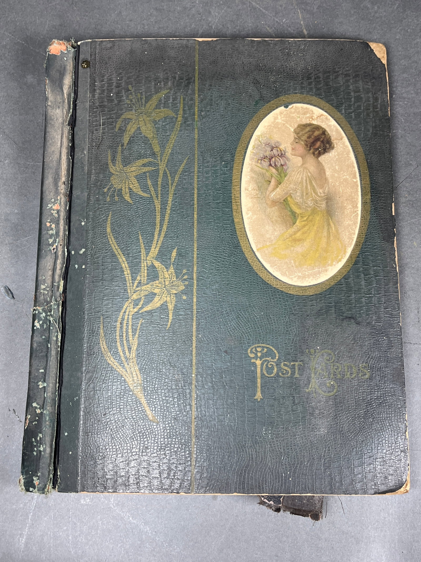 Two Early 20th-Century Postcard Albums Featuring 1913 Ohio Flood and Easter Greetings: A group of two early 20th-century postcard albums. The first album features a dark green textured cover decorated with an Art Nouveau gilt floral motif and a central oval portrait of a woman. The cont