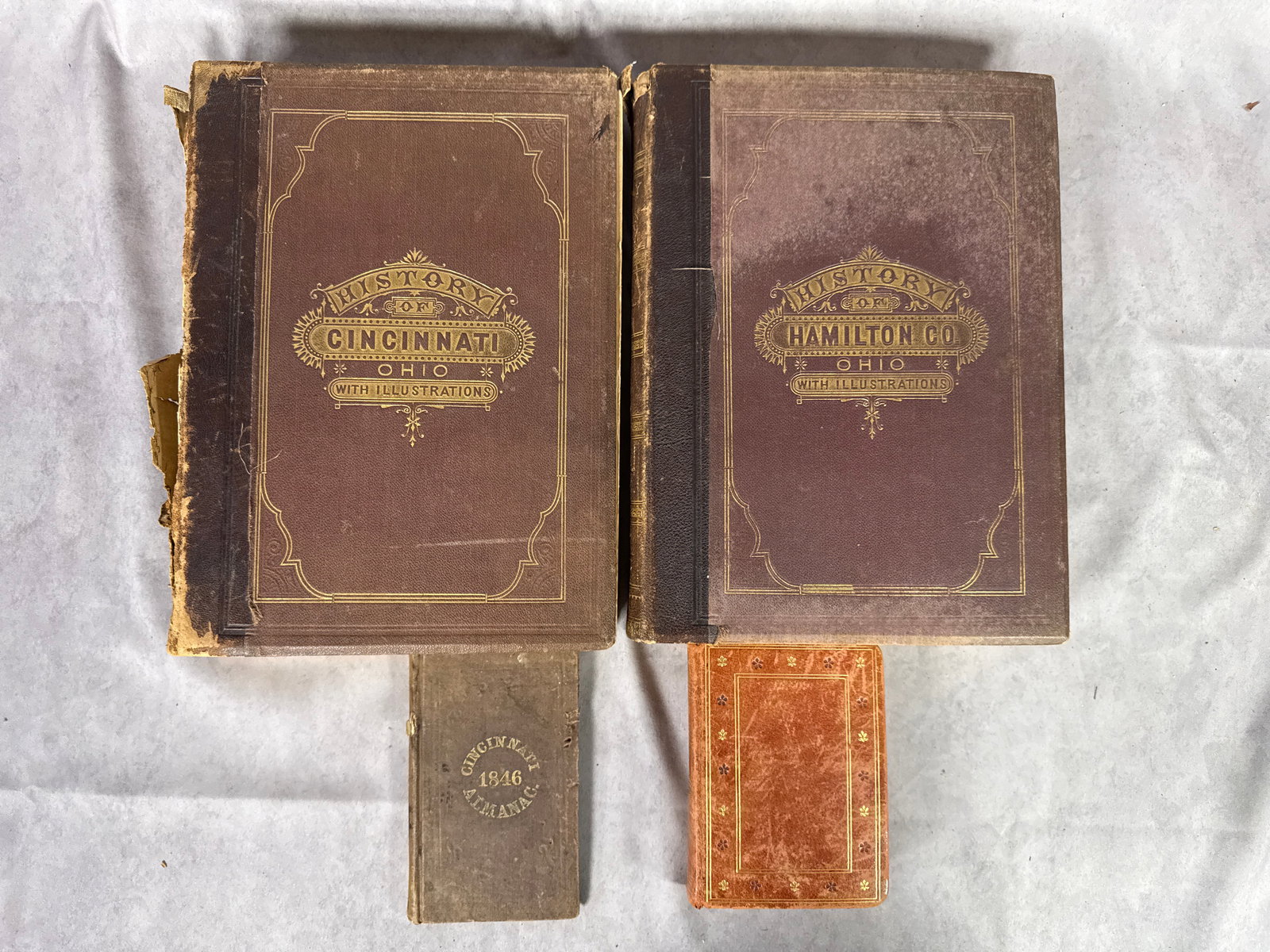A Collection of 19th-Century Ohio History Publications and Miniature Books: This collection includes several mid-to-late 19th-century volumes focused on Ohio regional history and general reference. The group features two large-format historical texts: History of Cincinnati,