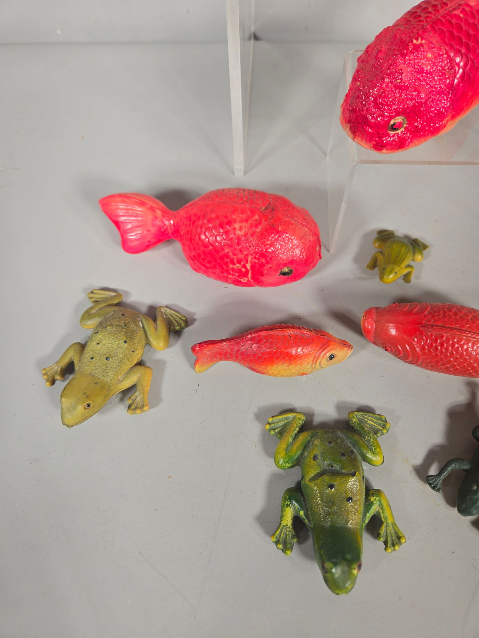 A Collection of Vintage Japanese Molded Plastic Aquatic Animal Figurines: A collection of vintage molded plastic or rubber aquatic animal novelties, manufactured in Japan. The assortment includes several fish of various species, multiple frogs in varying sizes, a lobster, a