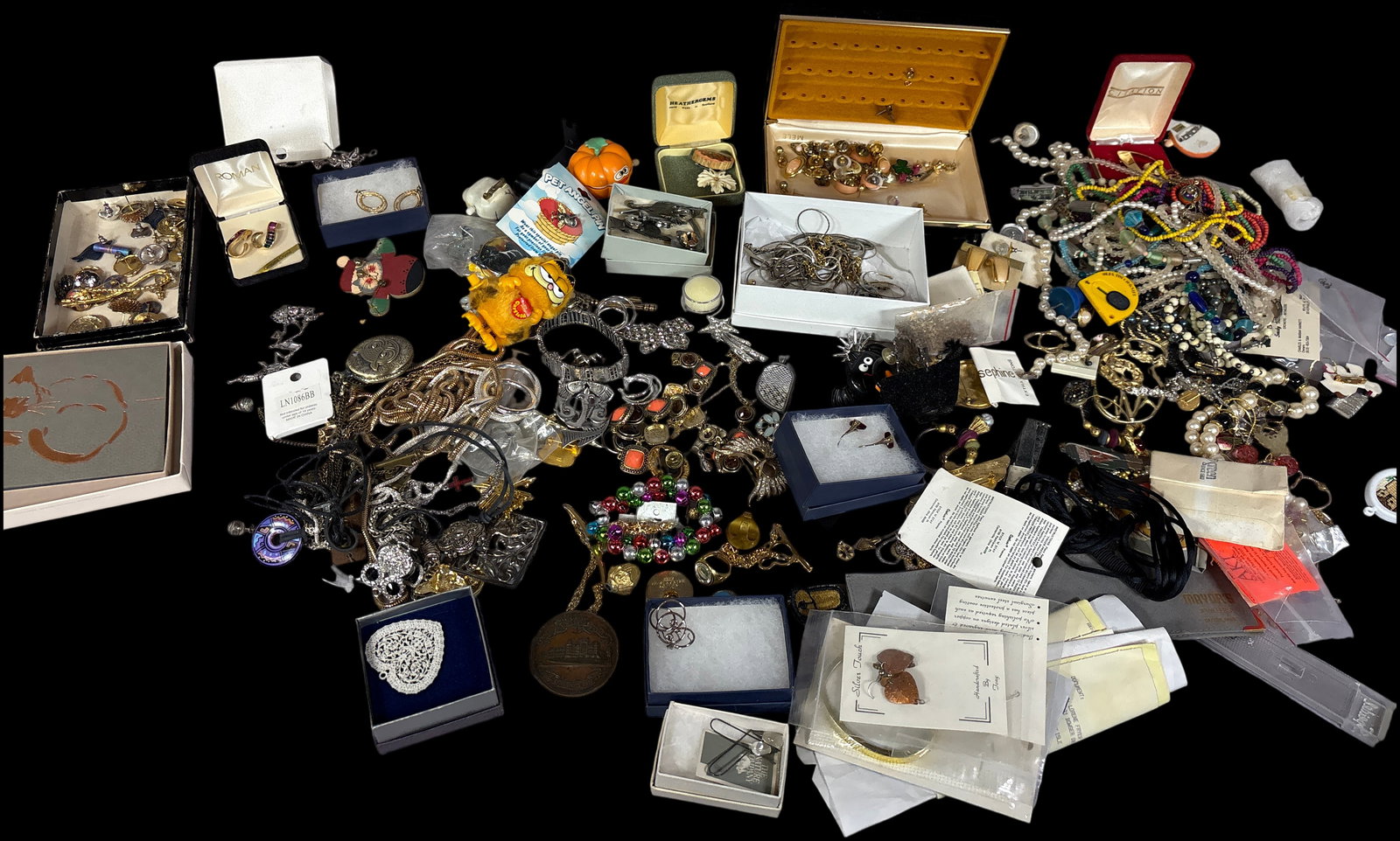 A Collection of Costume and Sterling Silver Jewelry: This collection of vintage and contemporary costume and sterling silver jewelry includes an assortment of necklaces, beaded strands, brooches, earrings, rings, and watches. Notable branded pieces incl