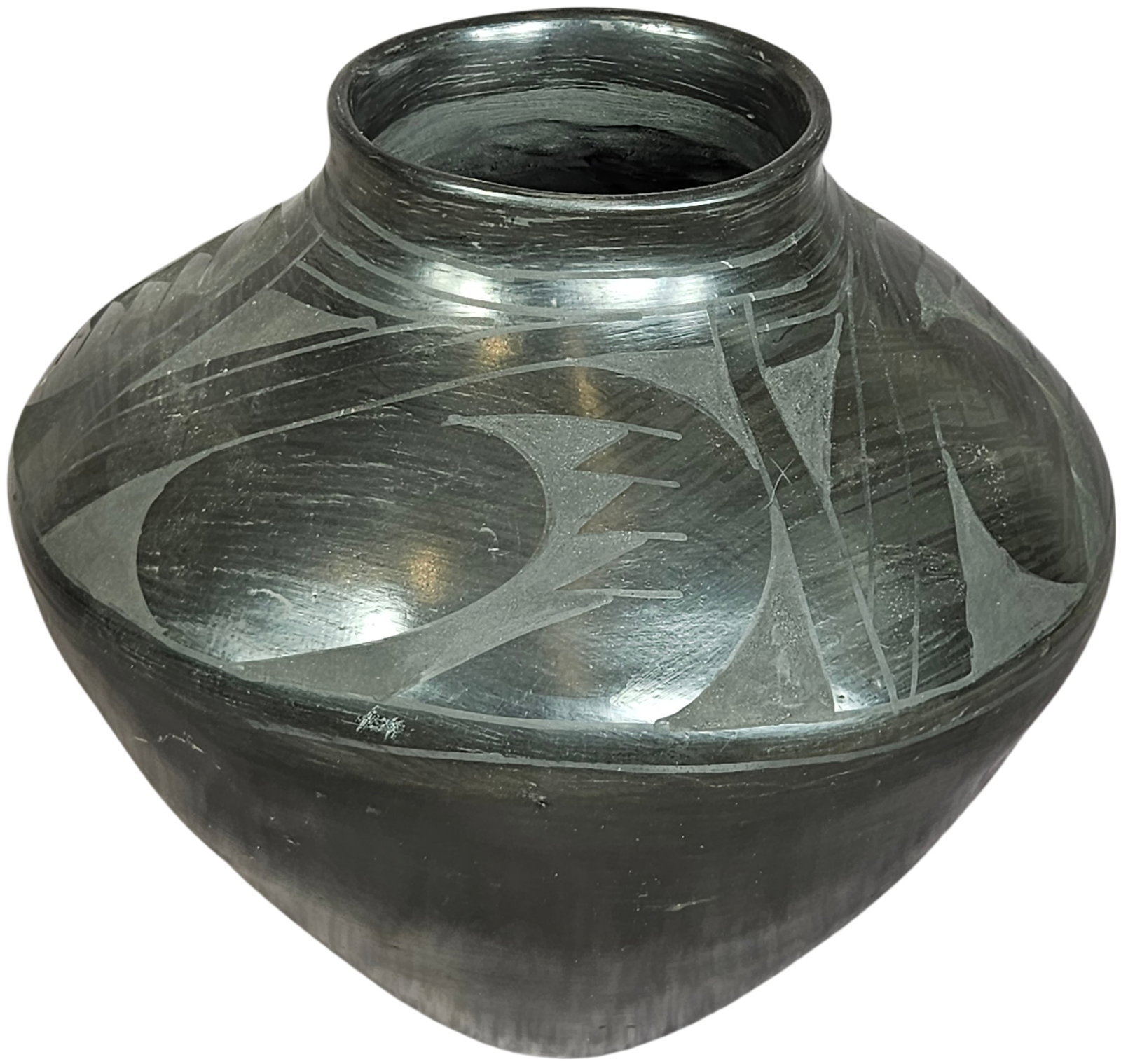 Mata Ortiz Black-on-Black Pottery Jar by Javier Corona: This Mata Ortiz black-on-black earthenware jar is a work by artist Javier Corona. The vessel features a wide, rounded body tapering to a short, flared neck and rim. The exterior is decorated with geom