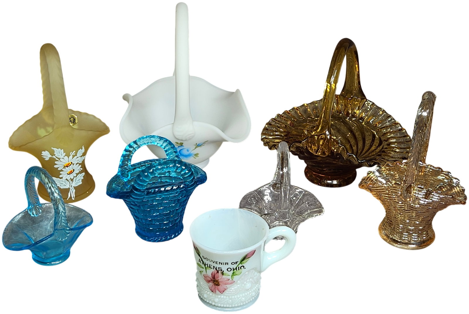 A Collection of Pieces of American Decorative Glassware Including Westmoreland and Hand-Painted: This lot features a group of pieces of decorative American glassware including various baskets and a souvenir mug. The collection includes a frosted yellow-to-amber Westmoreland satin glass basket wit