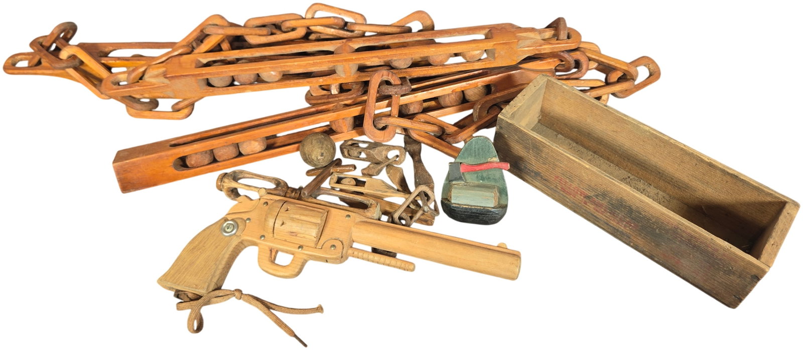 A Collection of Hand-Carved Wooden Folk Art Whimseys and Toys Dated 1967: An assortment of mid-20th-century American hand-carved wooden folk art items, including toys and complex whimsey carvings. The group features a detailed model of a revolver constructed from at least d