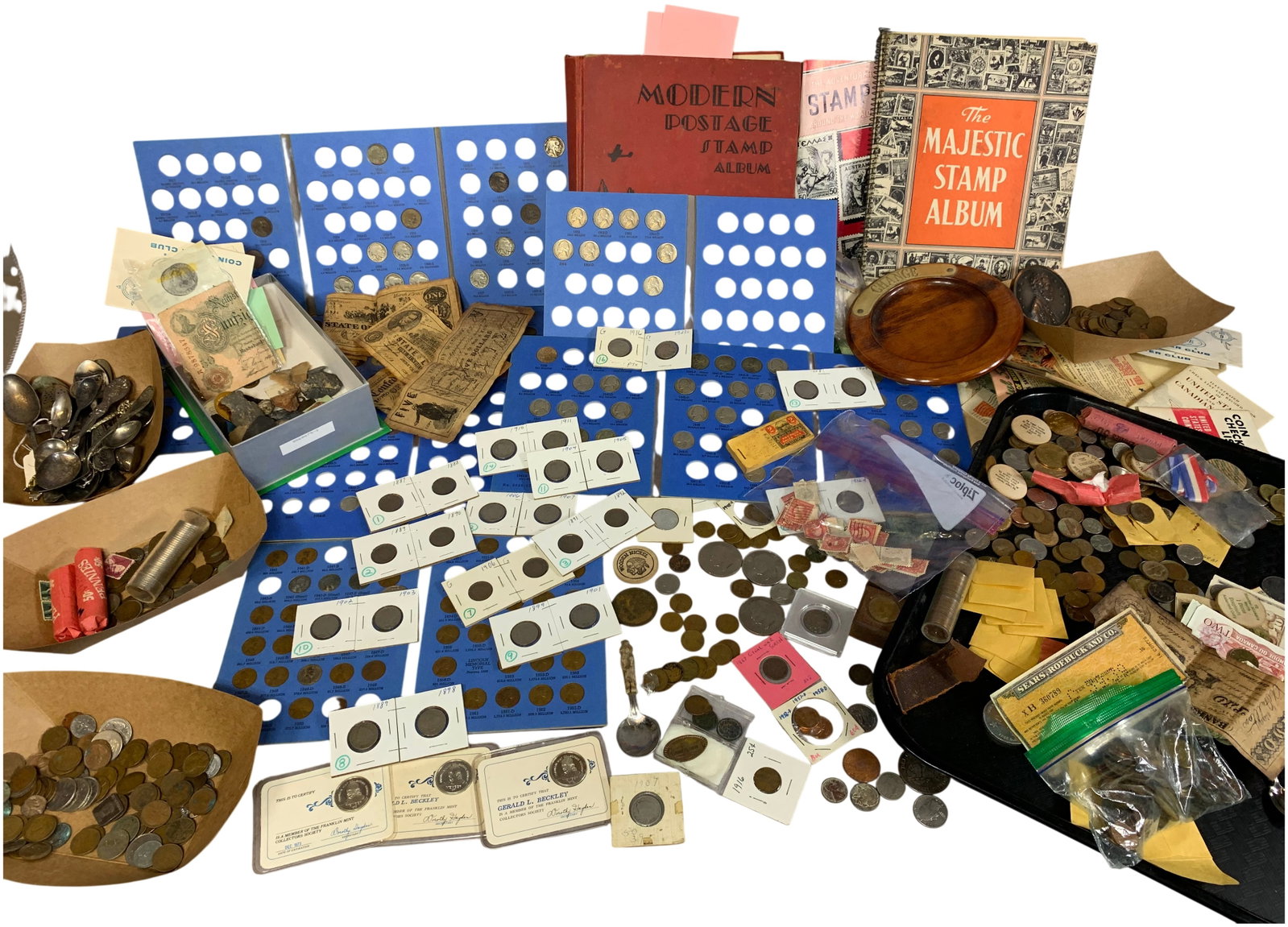 US and World Mixed Numismatic and Philatelic Estate Collection: A diverse estate collection containing an assortment of United States and international numismatic, philatelic, and historical items. The numismatic portion includes US Indian Head cents with dates ra