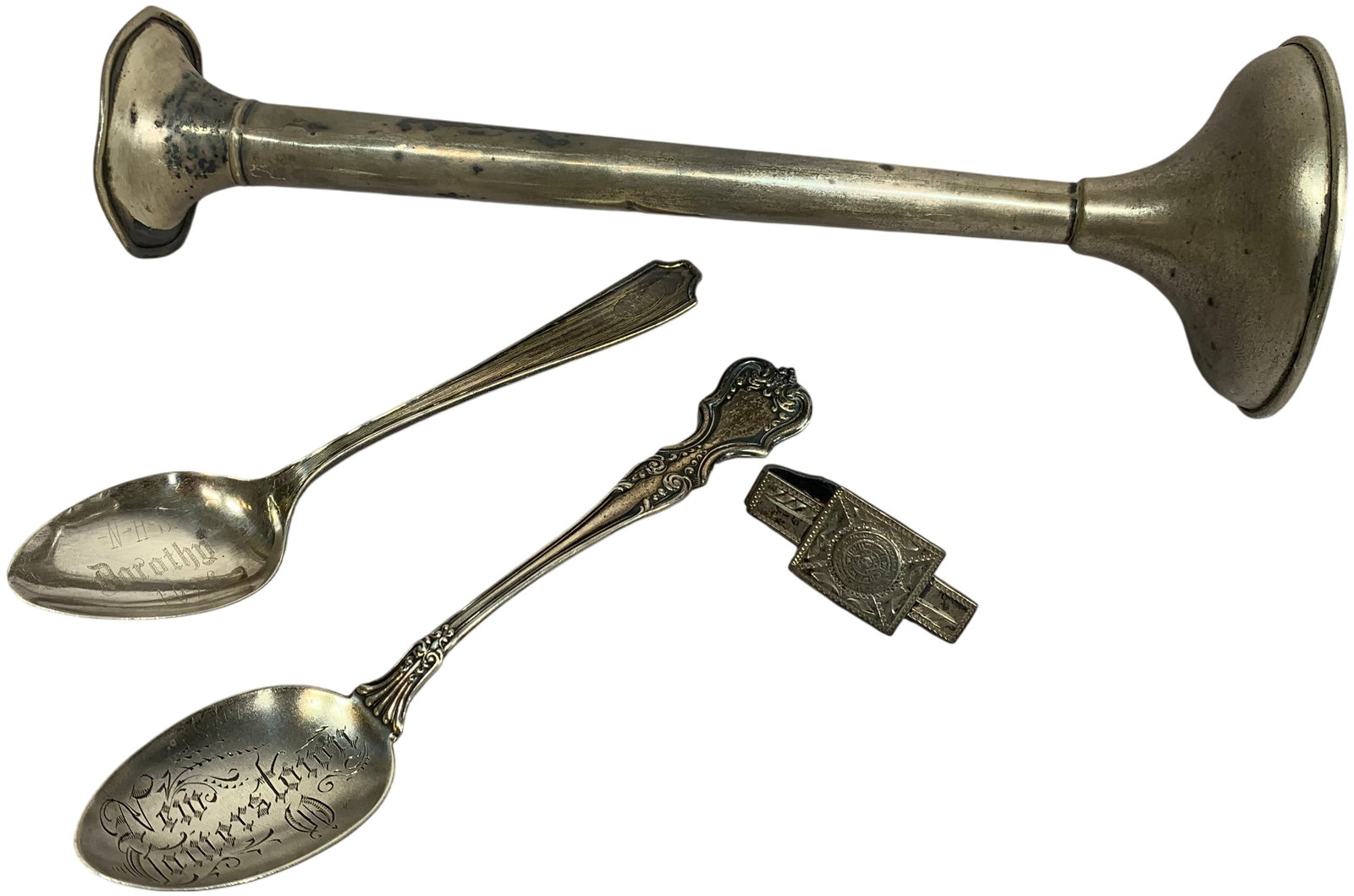 A Collection of Sterling Silver Items including a Weighted Bud Vase, Souvenir Spoons, and a Mexican: This lot features a collection of sterling silver items from the early to mid-20th century. Included is a trumpet-style bud vase with a slender, tapered body, ruffled rim, and a circular weighted