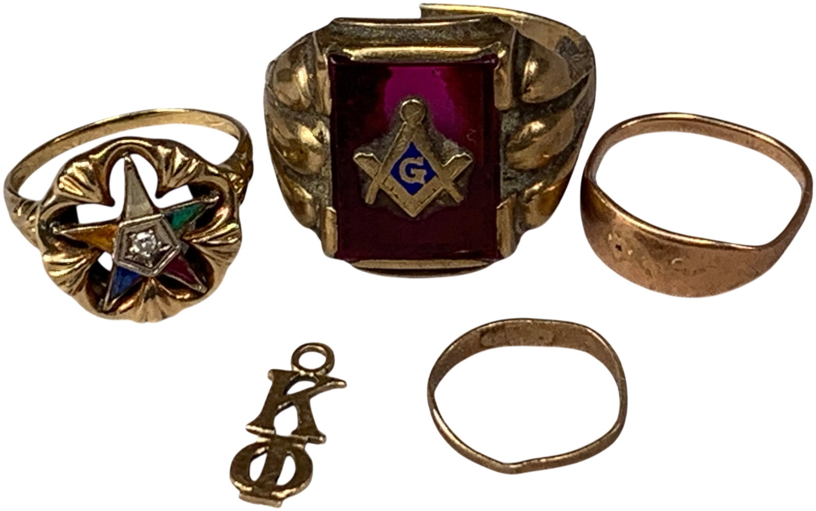 An Assortment of Karat Yellow Gold Jewelry Including Masonic and Fraternal Items: A collection of karat yellow gold jewelry featuring fraternal emblems and miscellaneous bands. The group includes an Order of the Eastern Star cocktail ring in a group of karat yellow gold, featuring