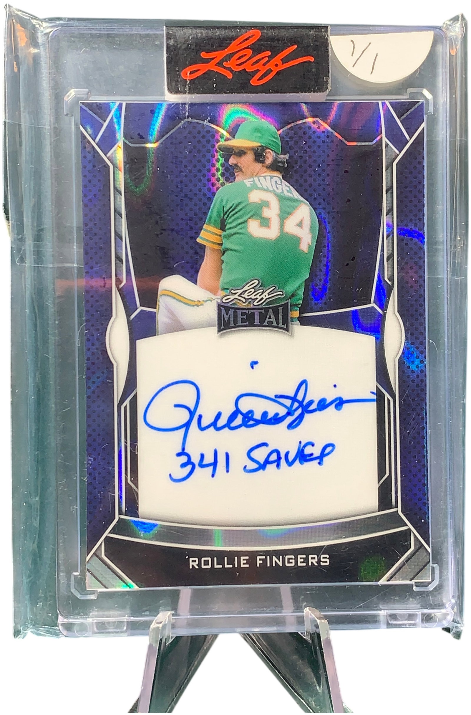 2023 Leaf Metal Rollie Fingers 1/1 Signed Blue Prismatic Trading Card I-RF1: This is a 2023 Leaf Metal trading card featuring Hall of Fame pitcher Rollie Fingers. The card is a unique 1/1 one-of-one Blue Prismatic parallel. It features an on-card autograph in blue ink by Rolli