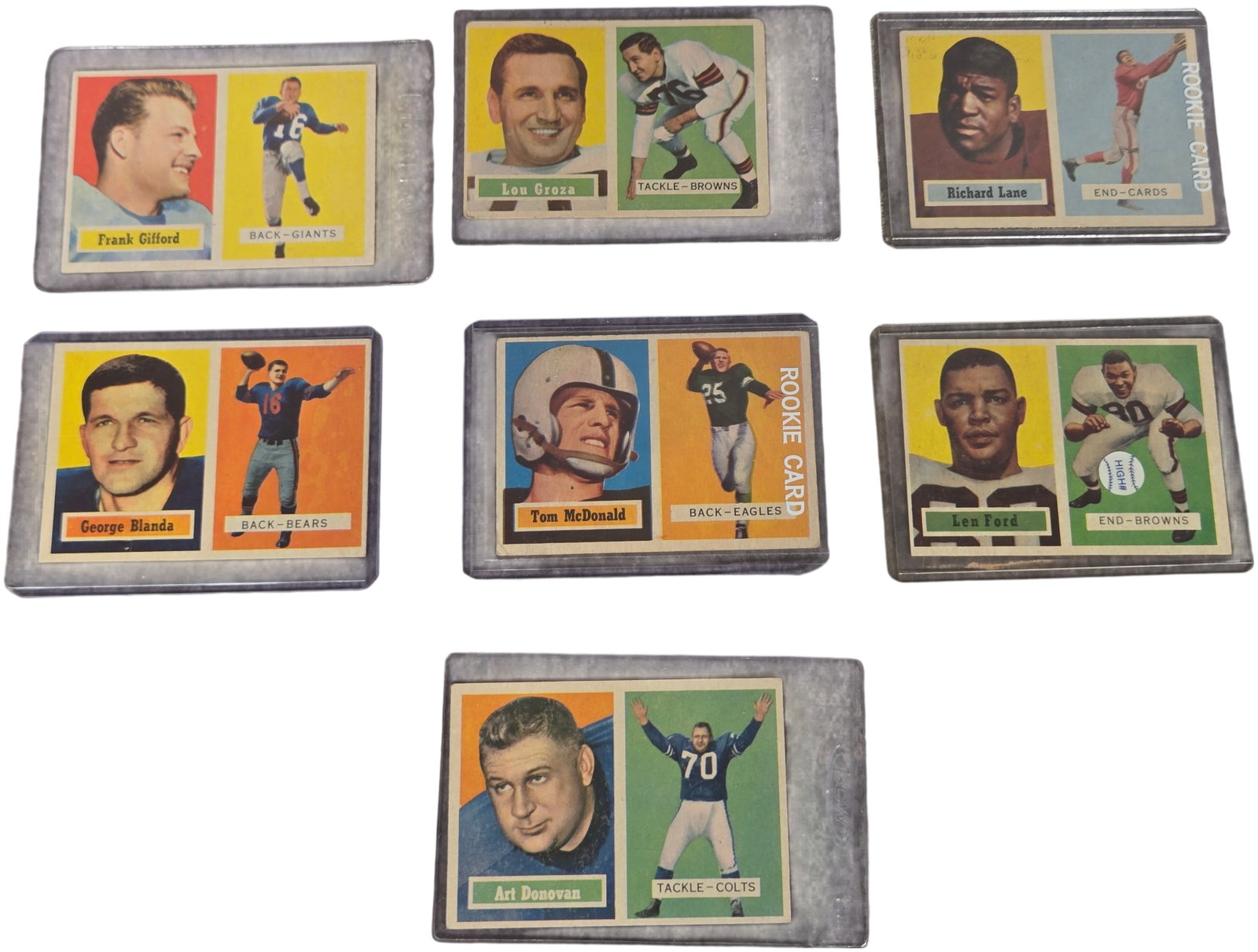 A Collection of Seven 1957 Topps Football Cards Featuring Hall of Fame Players and Rookies: A collection of vintage 1957 Topps American football cards. Each card is constructed from printed cardstock and features the iconic horizontal dual-image design of the 1957 set, depicting a player por