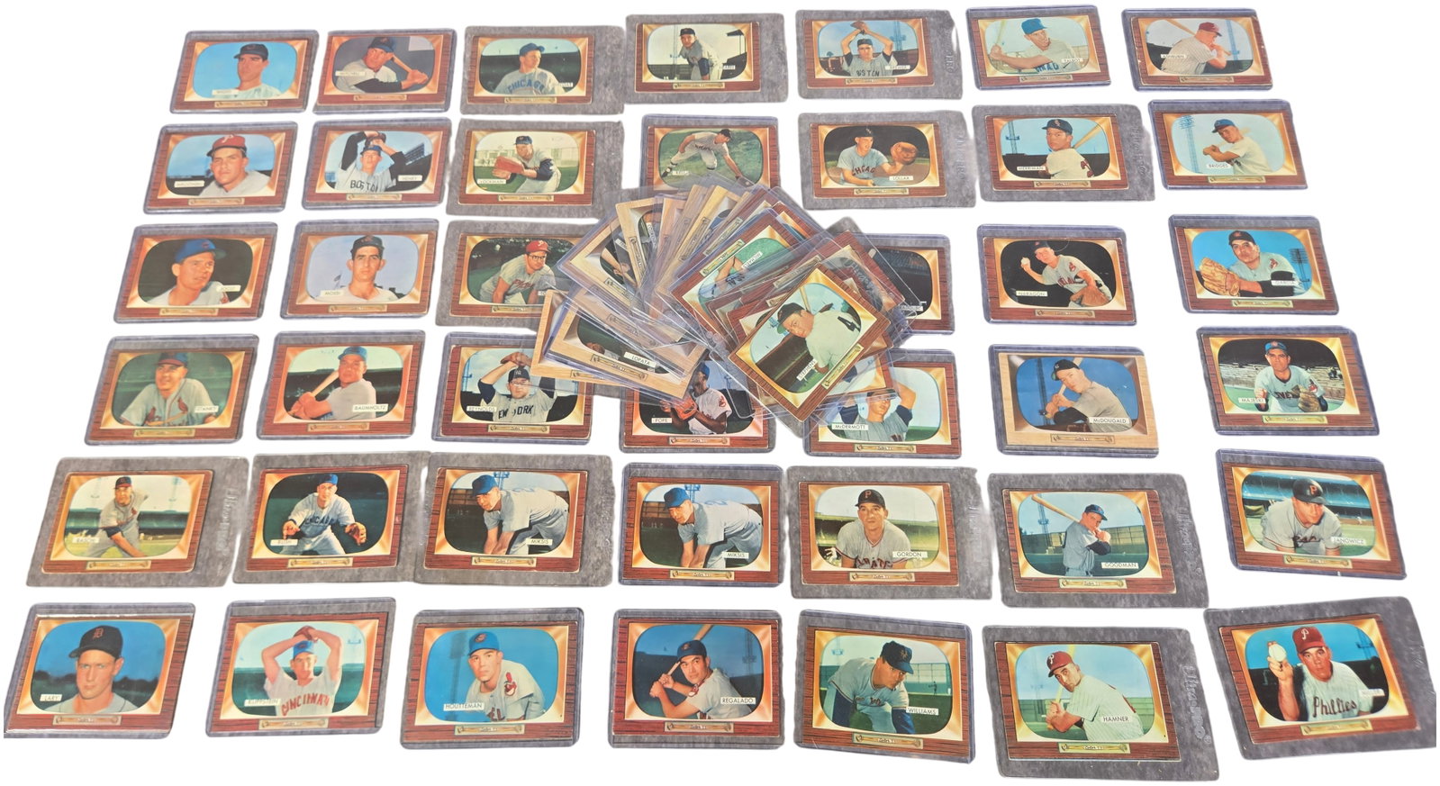 A Collection of 1955 Bowman Baseball Cards Including Richie Ashburn and Hall of Famers: This is a collection of vintage baseball cards from the 1955 Bowman series, distinguished by its unique Color TV wood-grain border design. The cards are presented raw and are individually housed in pe