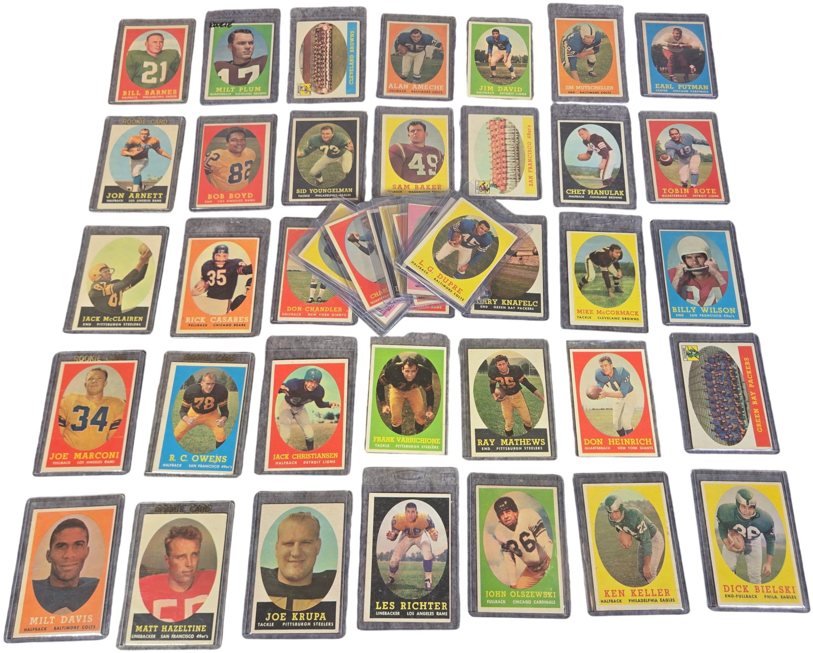 A Collection of 1958 Topps Football Cards Including Hall of Famers and Rookies: This collection consists of vintage 1958 Topps football cards. The cards feature the characteristic horizontal layout of the 1958 set, with player portraits or action shots set within oval frames agai