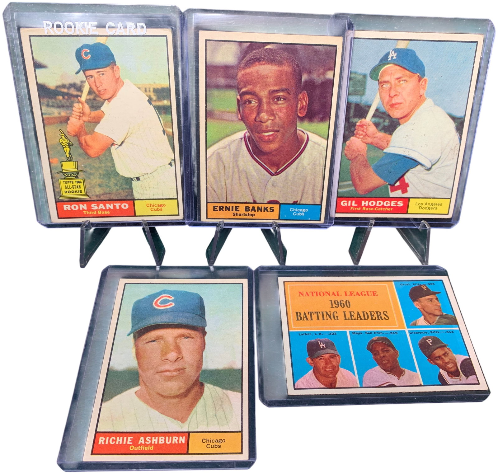 A Group of Five 1961 Topps Baseball Cards Including Ron Santo Rookie and Hall of Famers: This is a group of vintage baseball cards from the 1961 Topps set. The lot features several notable players from the National League, including Hall of Fame inductees and star athletes of the era. Eac