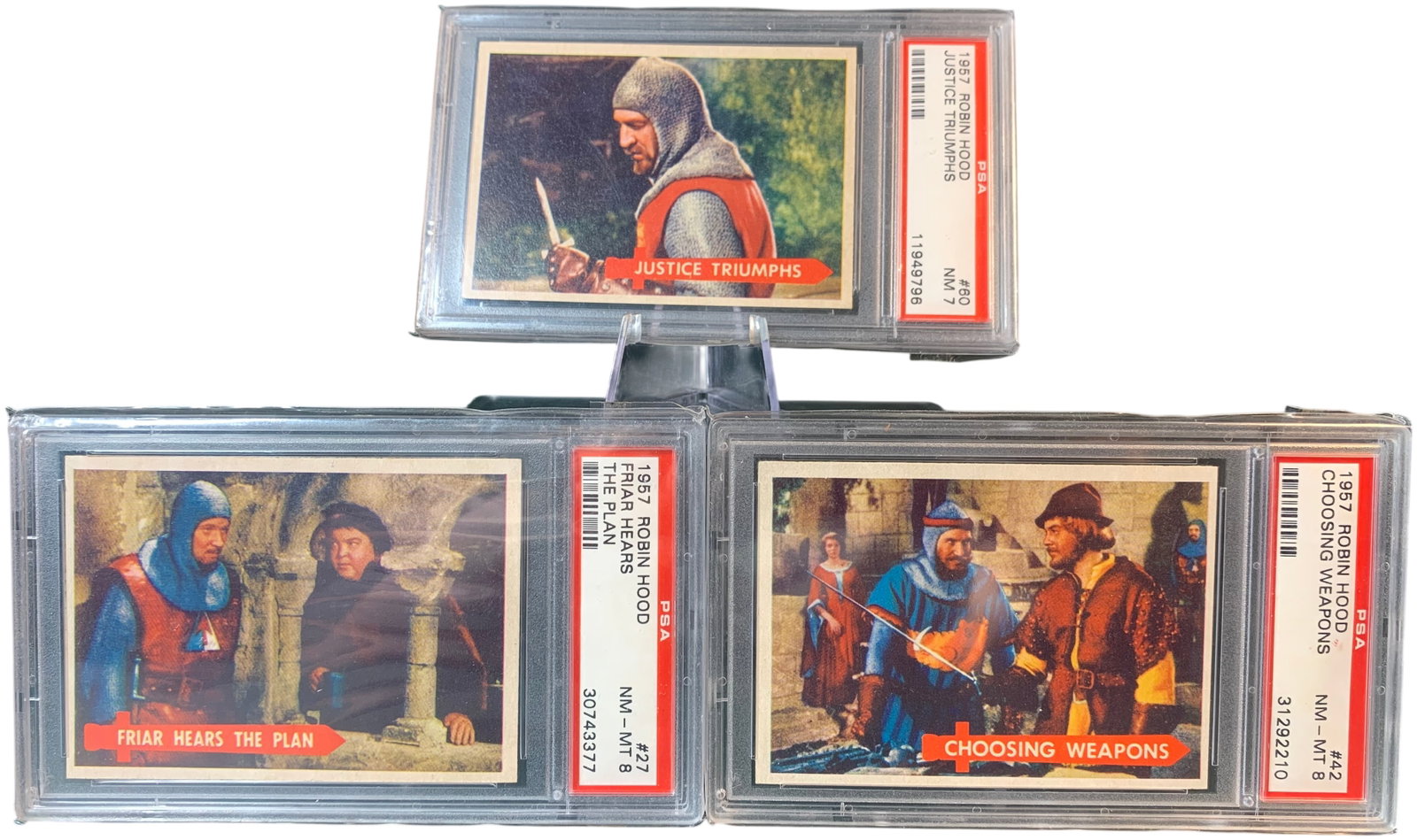 A Trio of 1957 Topps Robin Hood Non-Sport Trading Cards PSA Graded: This lot features a trio of vintage non-sport trading cards from the 1957 Robin Hood set, produced by Topps Chewing Gum (T.C.G.) in association with Official Films. The set is based on the popular tel