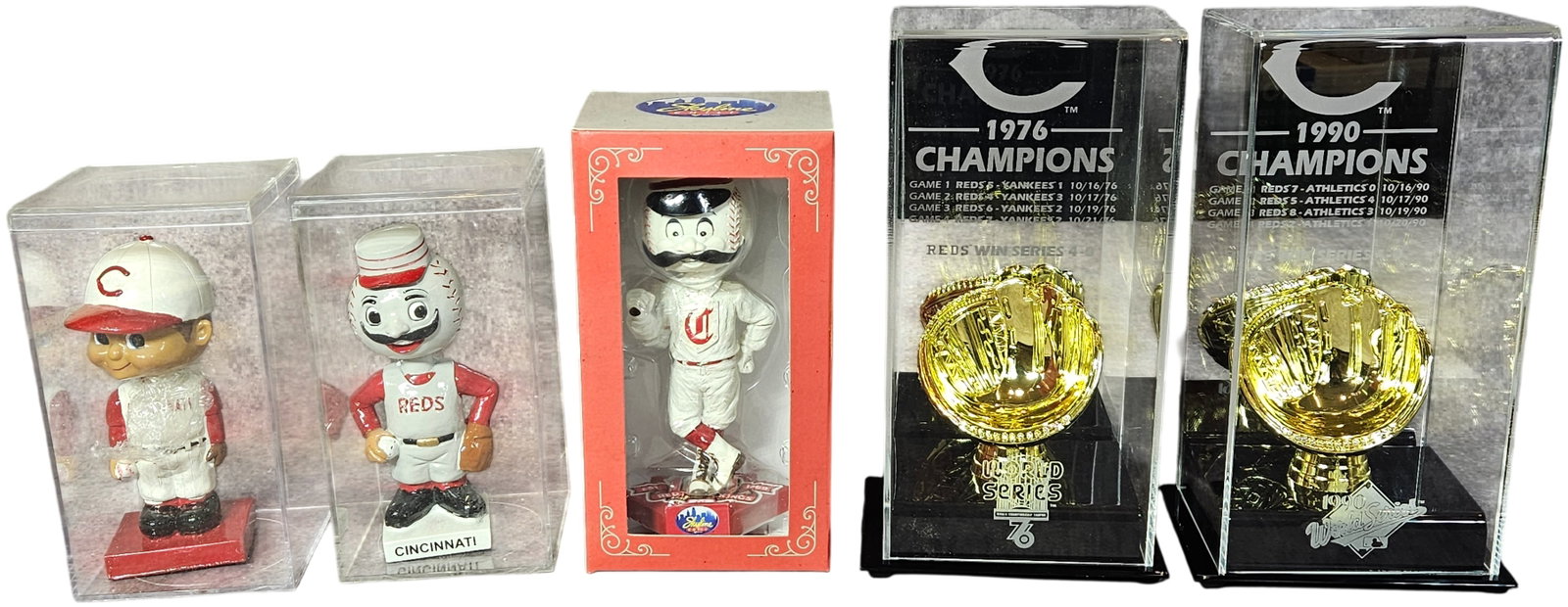 A Group of Cincinnati Reds Baseball Memorabilia Including World Series Trophy Replicas and: This group of Cincinnati Reds memorabilia features several commemorative items celebrating the franchise's history and championship seasons. Included are two vintage-style bobbleheads produced by Alex